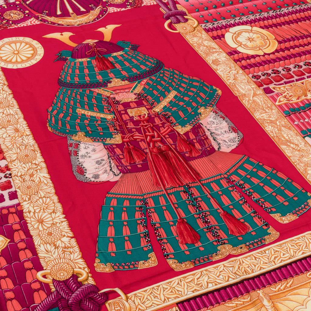 Guaranteed authentic Hermes Cashmere Silk 140cm shawl Parures de Samouraïs. 
Shawl with signature hand rolled edge. 
Vivid tones in vert, corail, and rose indien.
Exquisite composition designed by Aline Honore features a suit of armour and floral