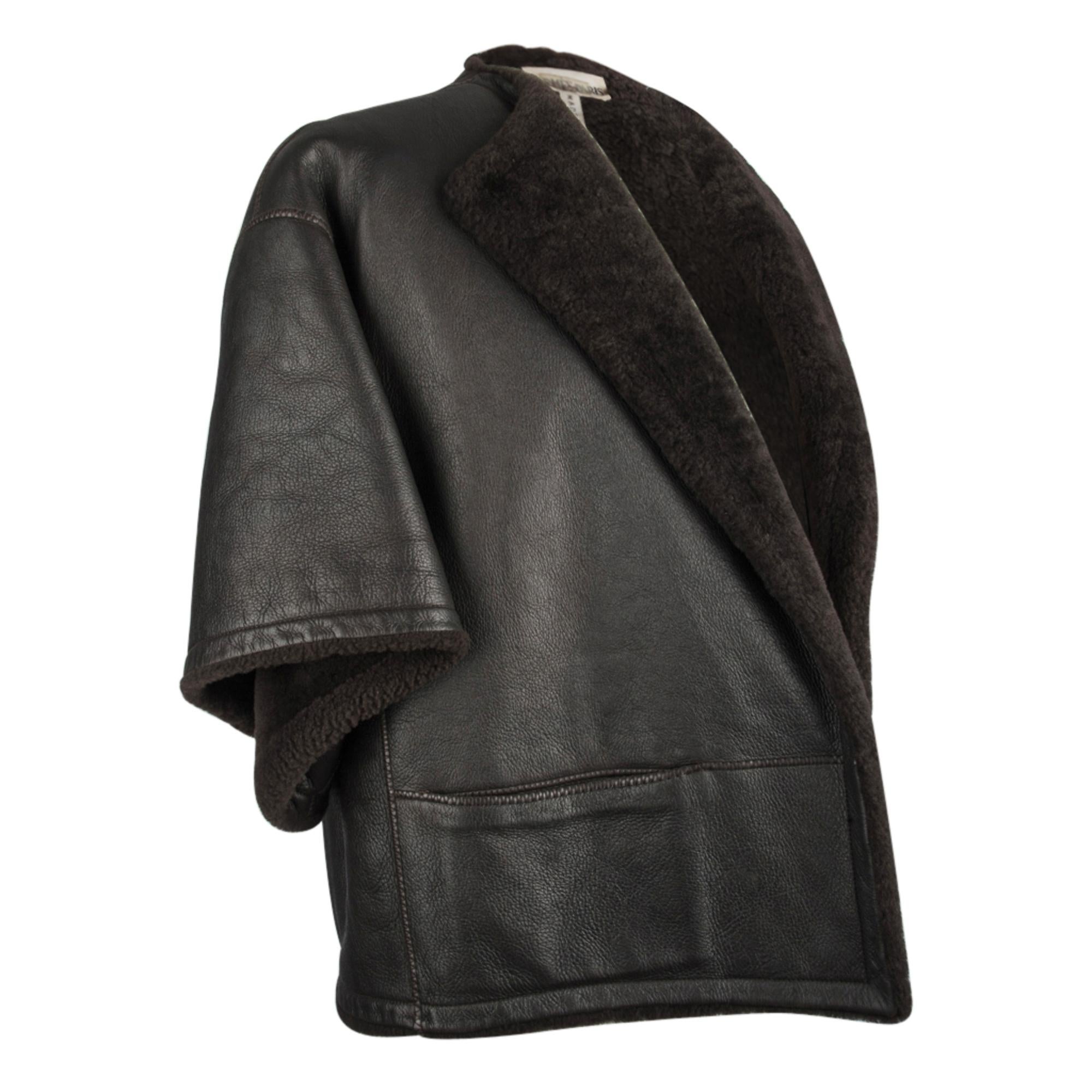 Mightychic offers an Hermes rich brown leather shearling capelet style jacket.  
Dark brown shearling jacket drop shoulder and 3/4 length wide sleeve.
2 front slash pockets.
Open - no closure. 
So chic.
Mightychic has excelled in customer service