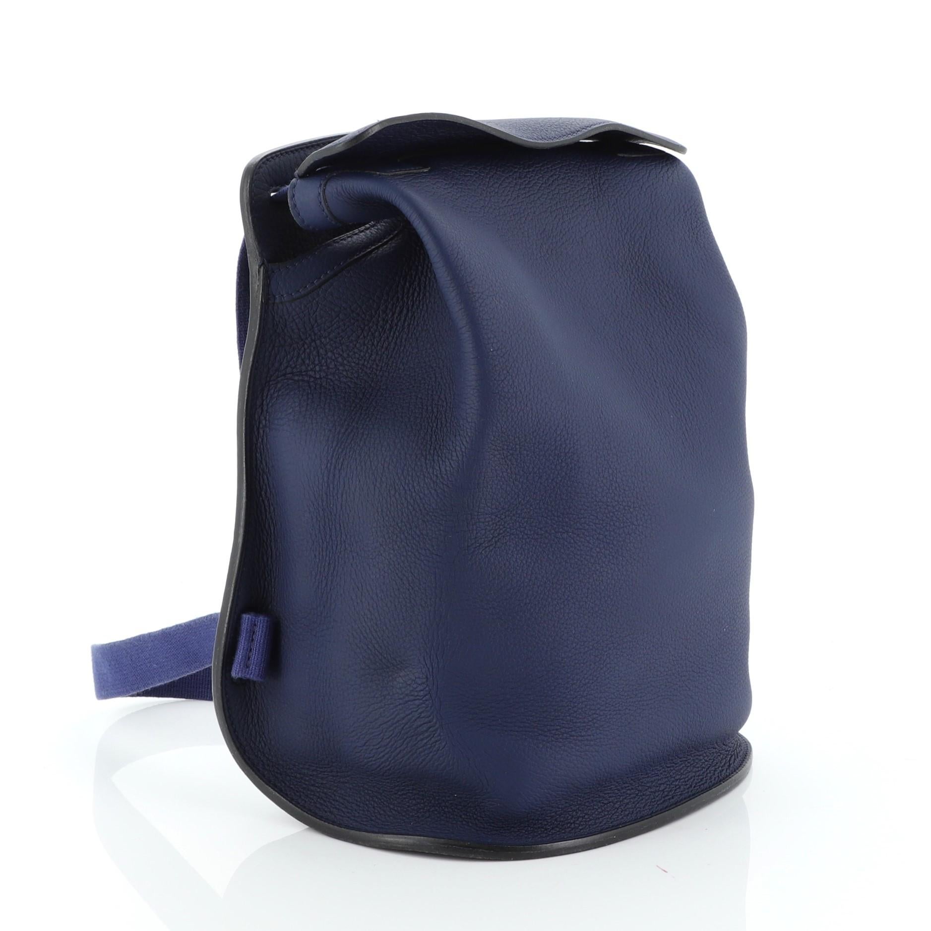 This Hermes Sherpa Backpack Togo, crafted from Bleu Saphir blue Togo leather, features nylon shoulder straps. It opens to a Bleu Saphir blue raw leather interior with slip pocket. Date stamp reads: A Square (1997). 

Condition: Good. Heavy loss of