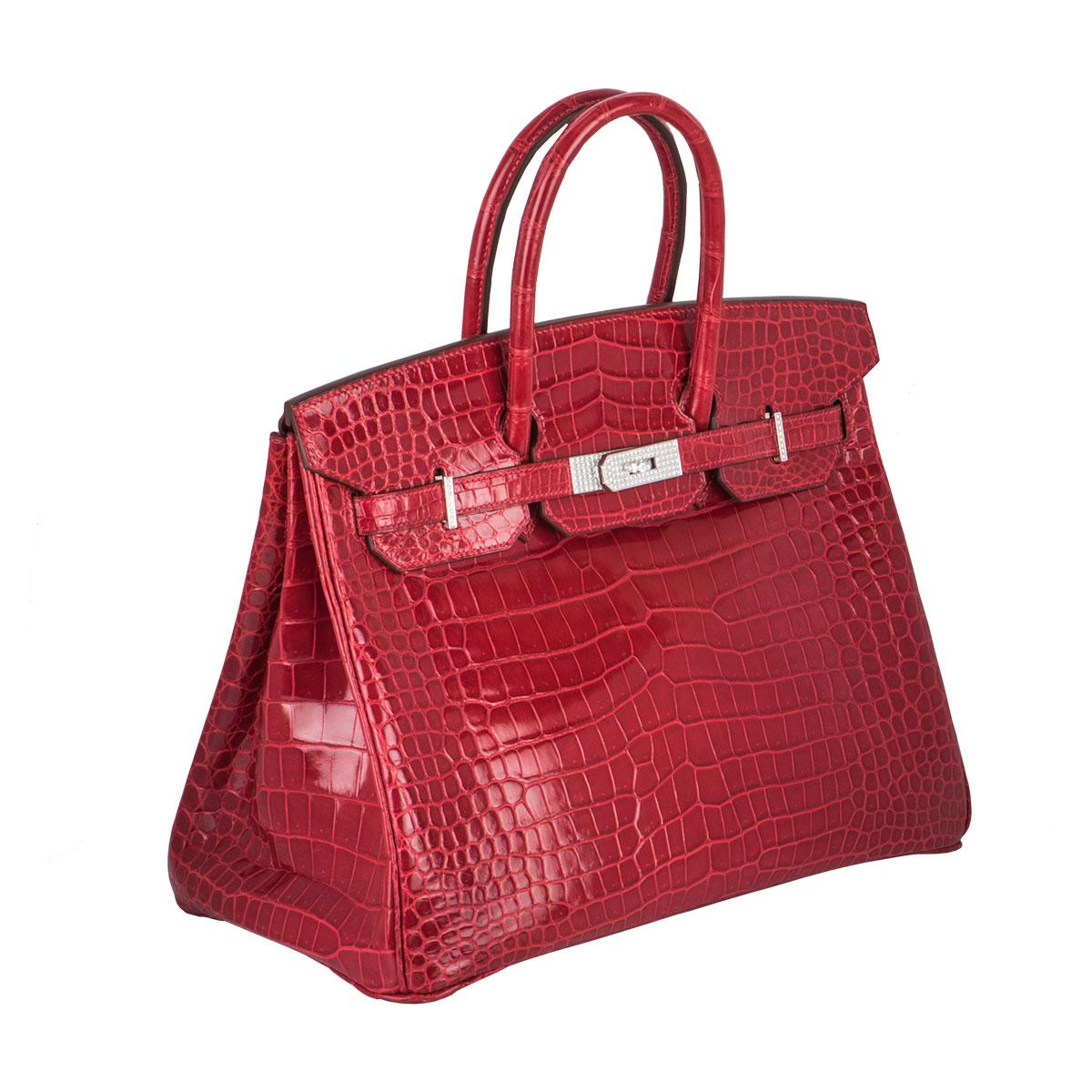 An exquisite Hermès 35cm Birkin Bag. A sort after piece this exotic shiny braise Porosus Crocodile bag, detailed with white gold hardware and set with round brilliant cut diamonds totalling approximately 10.00ct. The bag has dual rolled top handles