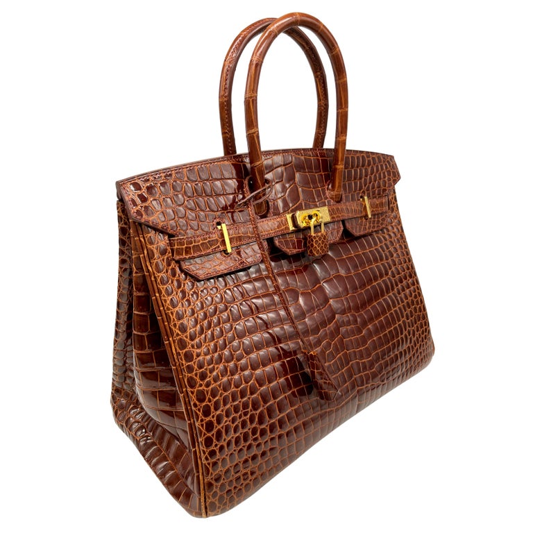 Extremely Rare Hermés Shiny Miel Porosus Crocodile 35cm Birkin Bag with Gold Hardware, 2008. Originally introduced in the Late 20th Century, the Birkin bag was created during a chance encounter between two iconic figures, actress Jane Birkin and