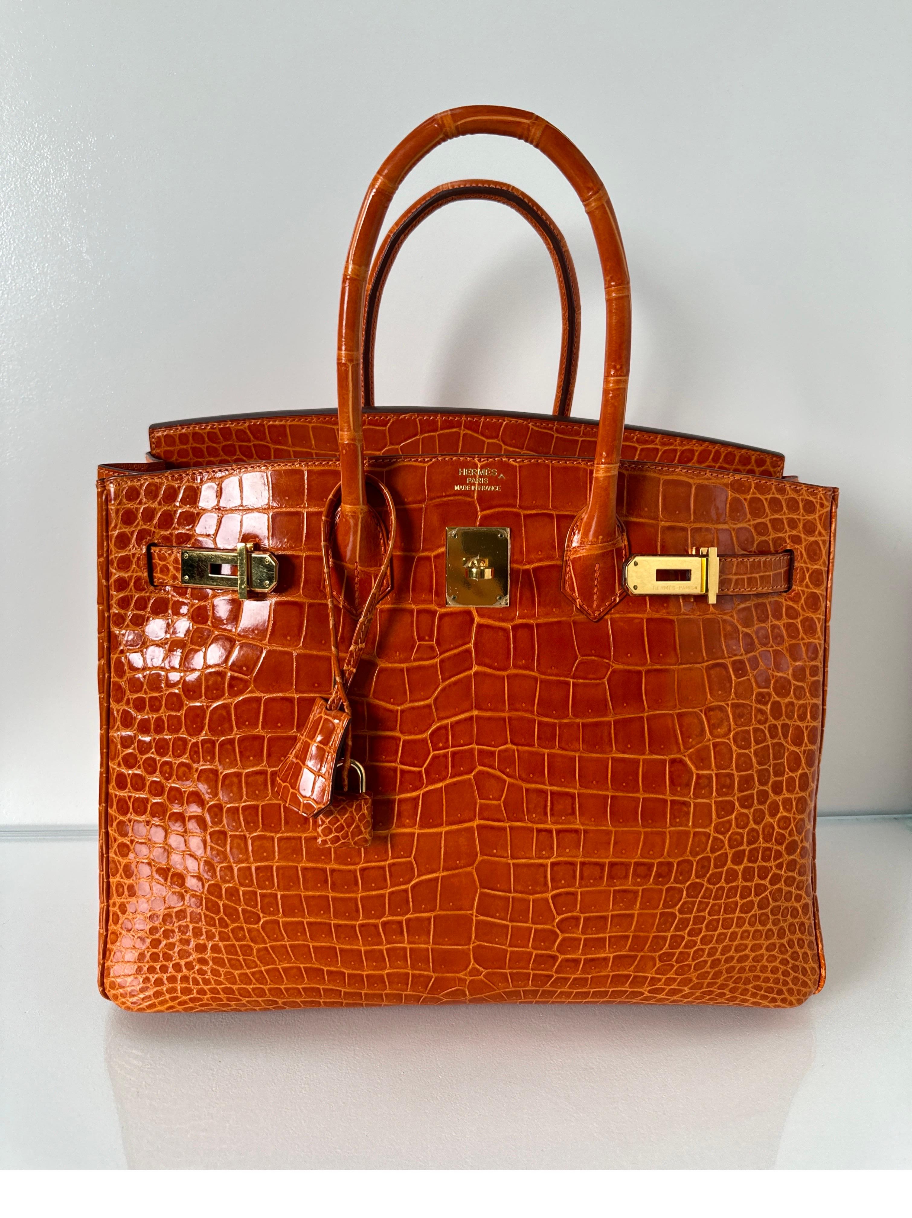 Hermes Orange Shiny Porosus Crocodile Birkin 35 Bag. Excellent condition. Looks like new condition. Gorgeous exotic leather bag. Rare combination. Gold hardware. Interior clean. Priced to sell. Great investment bag. Includes Cites. P stamp. Full