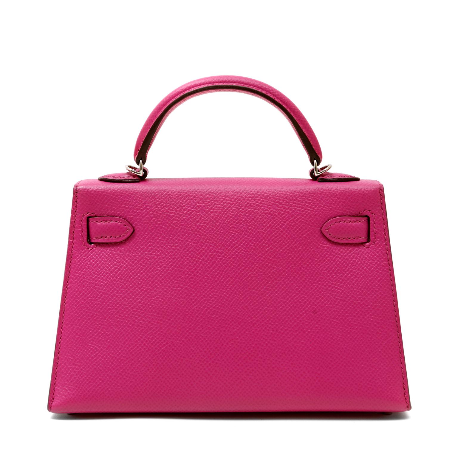 This authentic Hermès Shocking Pink Epsom Mini Kelly is pristine with the protective plastic intact on the hardware.  Petite and feminine, the crossbody Kelly is very collectible in the 20 cm silhouette.
Vivid pink Epsom leather is textured and