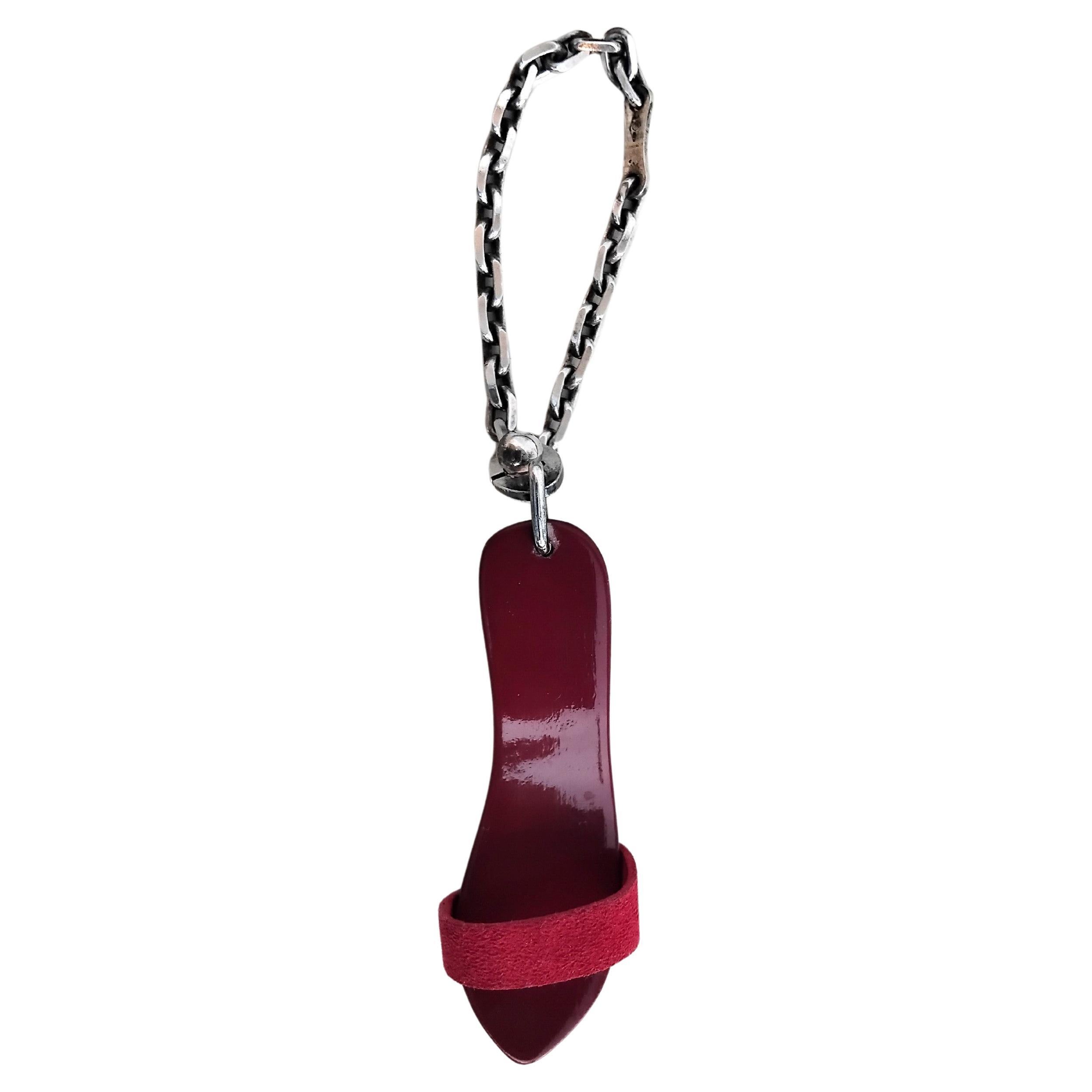 Extremely Rare Authentic Hermès Key Chain 

Great gift for shoes lovers !

This little mule has nothing to envy the big ones! Identical reproduction, carved from wood, lacquered for a glossy finish, decorated with a leather band and it even has a