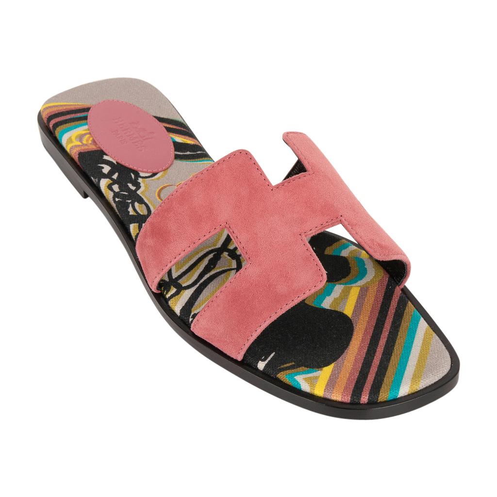 Guaranteed authentic Hermes Oran exquisite Rose de Venise slide.
The iconic top stitched H cutout over the top of the foot in sublime goatskin suede.
Brides de Gala print insole in toile. 
Wood heel with leather sole. 
Comes with sleepers and and