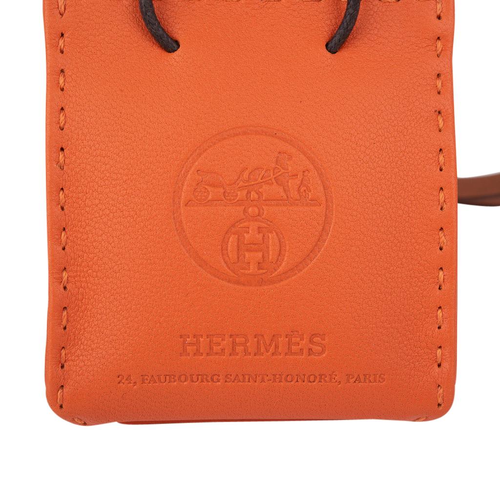 Mightychic offers an Hermes Orange Shopping Bag charm in Swift leather.
This delightful charm, in the shape of an Hermes bag comes in Orange with small Black handles and Gold strap.
Whimsy true to the nature of Hermes.
Stamped with the iconic Hermes