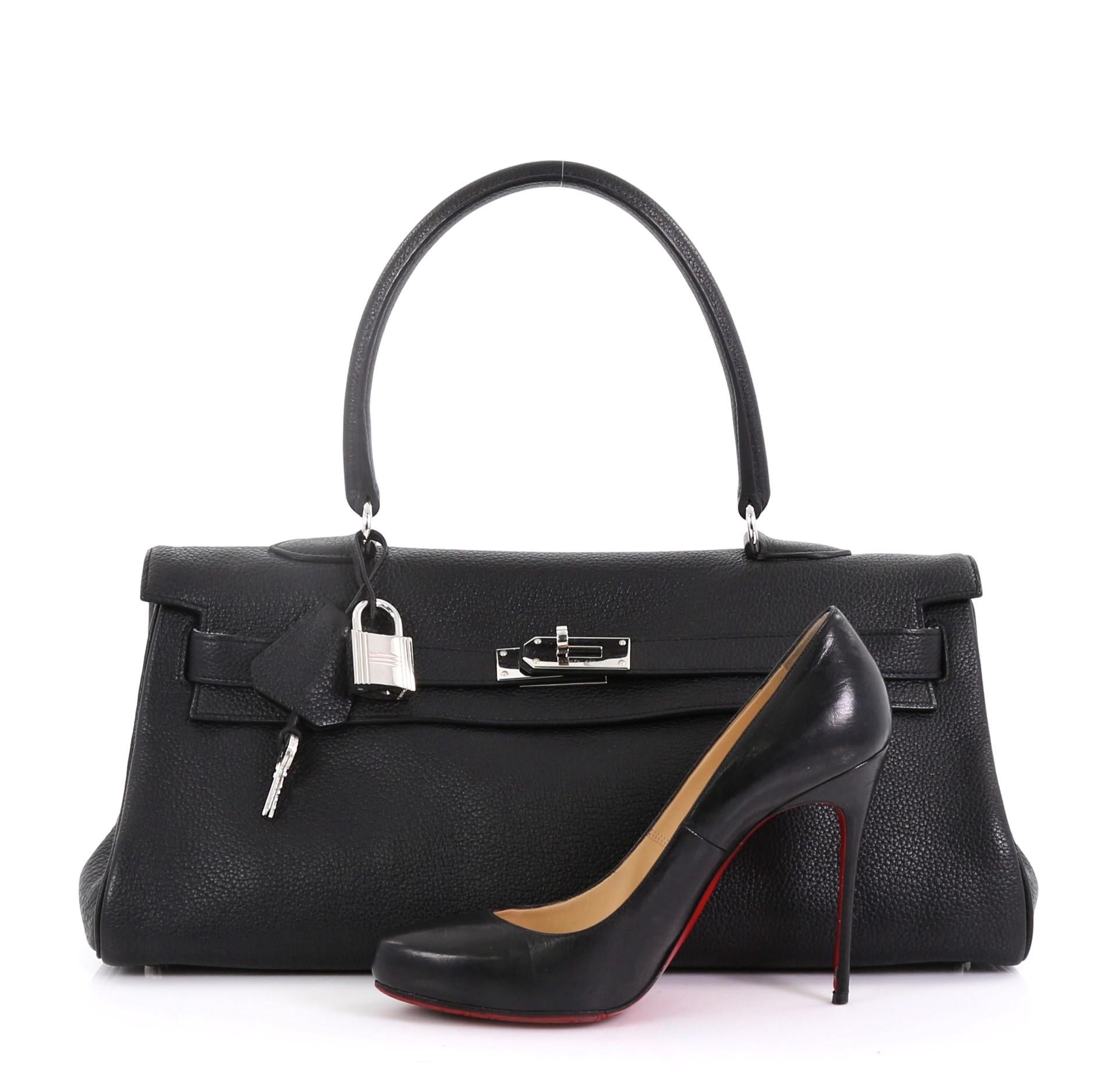 This Hermes Shoulder Kelly Handbag Clemence 42, crafted in Noir black Clemence leather, features single rolled top handle, a frontal flap, and palladium hardware interior. Its turn-lock closure opens to a Noir black Clemence leather interior with