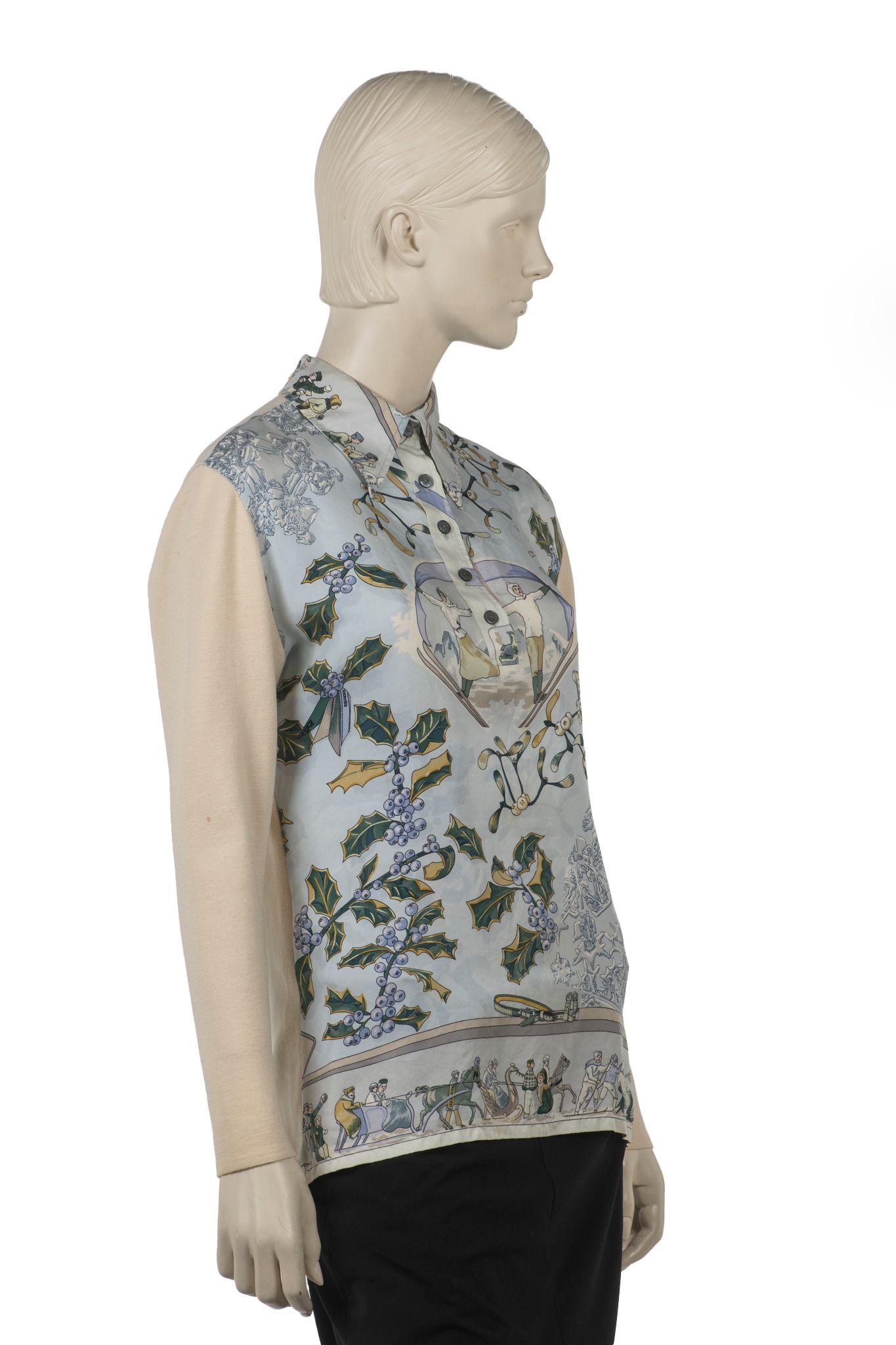 Questo top stampato in seta e lana di Hermès, di colore blu, presenta una manica lunga con colletto e una chiusura con bottoni sul davanti. Un disegno di Caty Latham apparso originariamente nel 1989Piccola macchia sulla manica, vedi foto.
La taglia