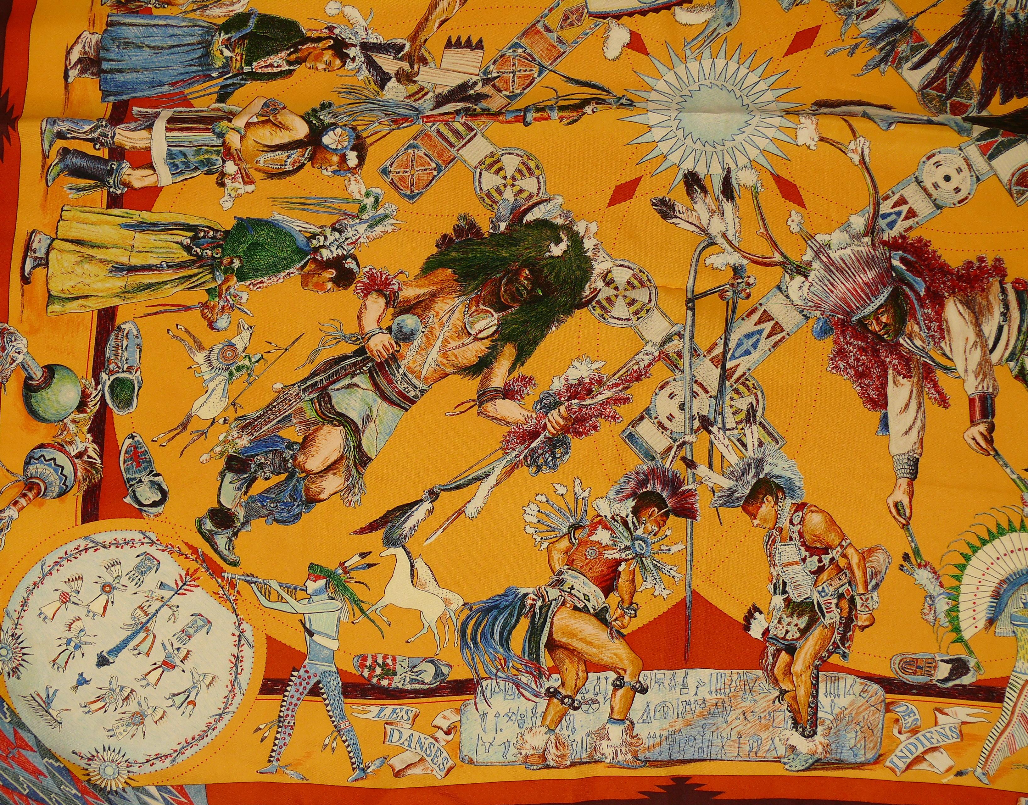 HERMES vintage highly sought after silk carre scarf LES DANSES DES INDIENS (THE DANCES OF THE NATIVE AMERICAN INDIANS) designed by native Texan KERMIT OLIVER.

This scarf design depicts Native American Indians dances as well as Native American art