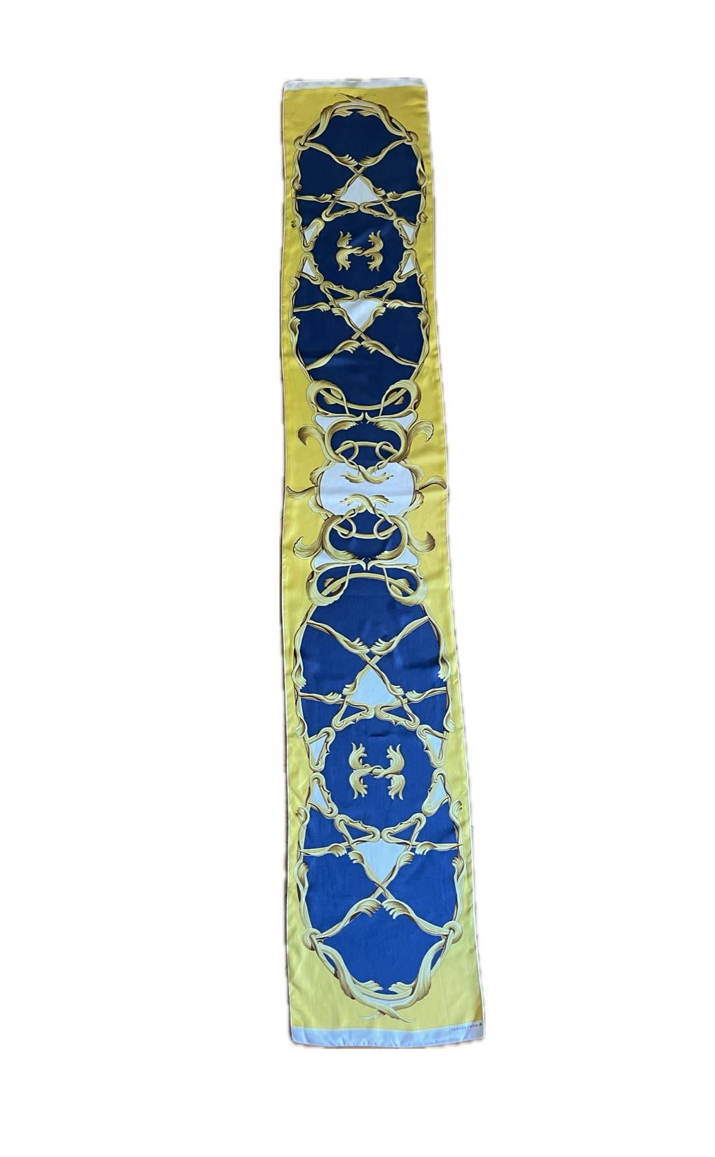 Hermès Silk Maxi Twilly Yellow & Blue. This beautiful scarf has unique designs that will elevate any of your outfit. The colors are bold, vibrant but easy to wear year round. Rare piece that can be considered a collectible, making this a really