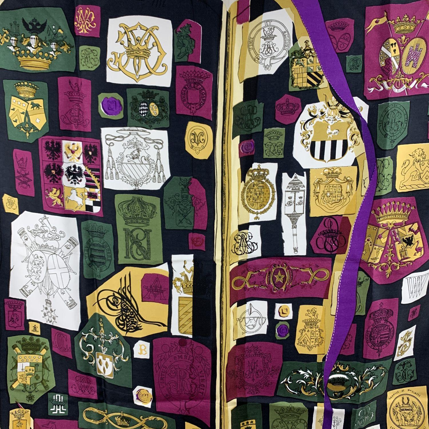 Rare HERMES Silk scarf named 'Chiffres et Monogrammes (Année 1886)', created by artist Lise Coutin. It depicts an open book with various designs of crests and monograms. The scarf was first issued in 1962 and then it was reissued in 1998. This was