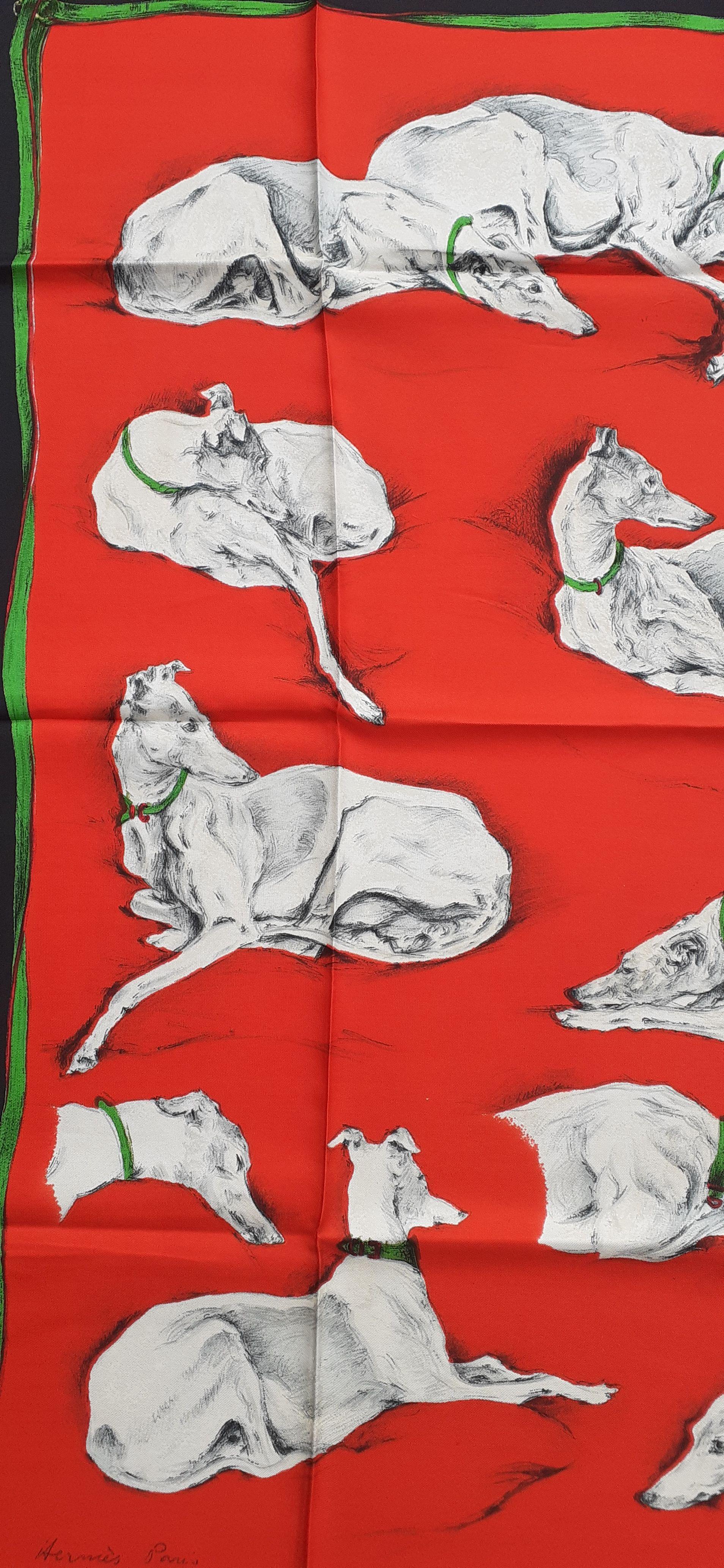 Stunning Authentic Hermès Scarf
 
Print: Lévriers (Greyhound dogs)

Design by Xavier De Poret in 1956

Made in France

Made of 100% Silk

Colorways: Black border, Red background, Beige and Grey Greyhounds with Green necklace


