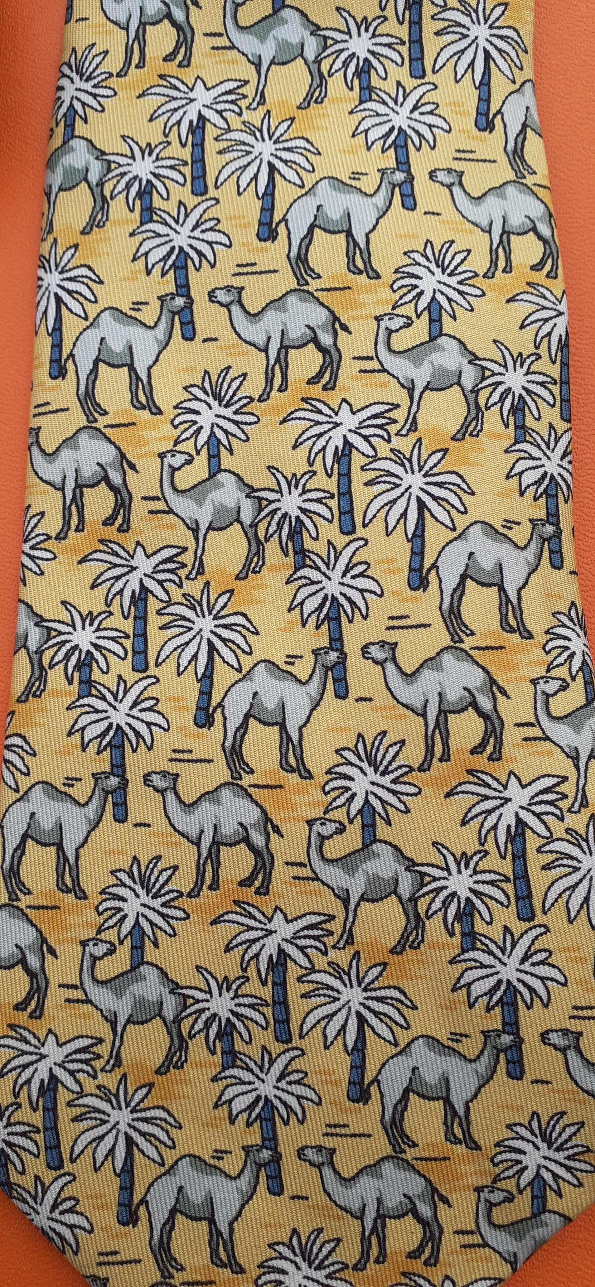 Please note: yellow is more vivid in reality than on the photos

Lovely Authentic Hermès Tie

Print: Camels and Palm Trees

Made in France

Made of 100% Silk

Colorways: Yellow, White, Grey

Lined with plain yellow silk

Carriage and 
