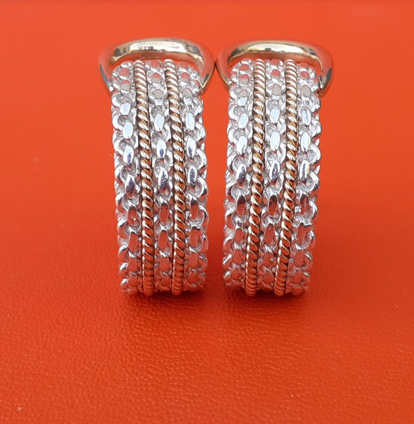 Absolutely Gorgeous Authentic Hermès Earrings

Pattern: Silver chain enhanced with 2 twisted yellow gold threads

The upper loop is in yellow gold

Clip-on earrings, will fit non pierced ears

Made of Silver and Yellow Gold 18K

Colorways: Silver,