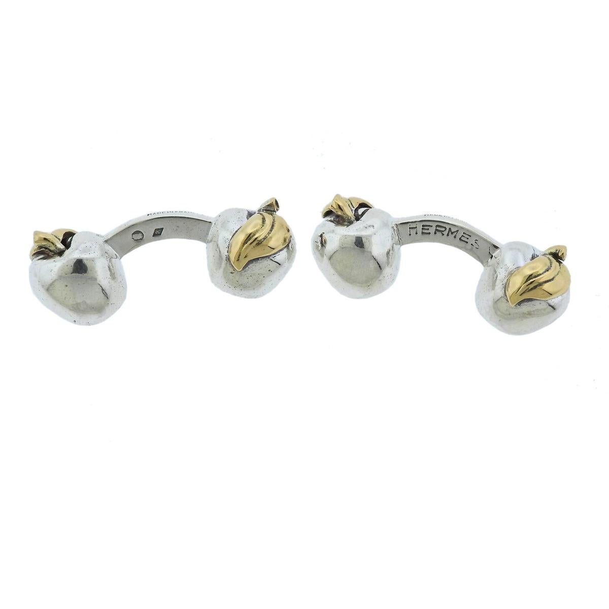Pair of sterling silver and 18k gold apple cufflinks, designed by Hermes. Each top (apple) measures 11mm x 9mm, weigh 22.3 grams. Marked: Hermes, Punchmarks.