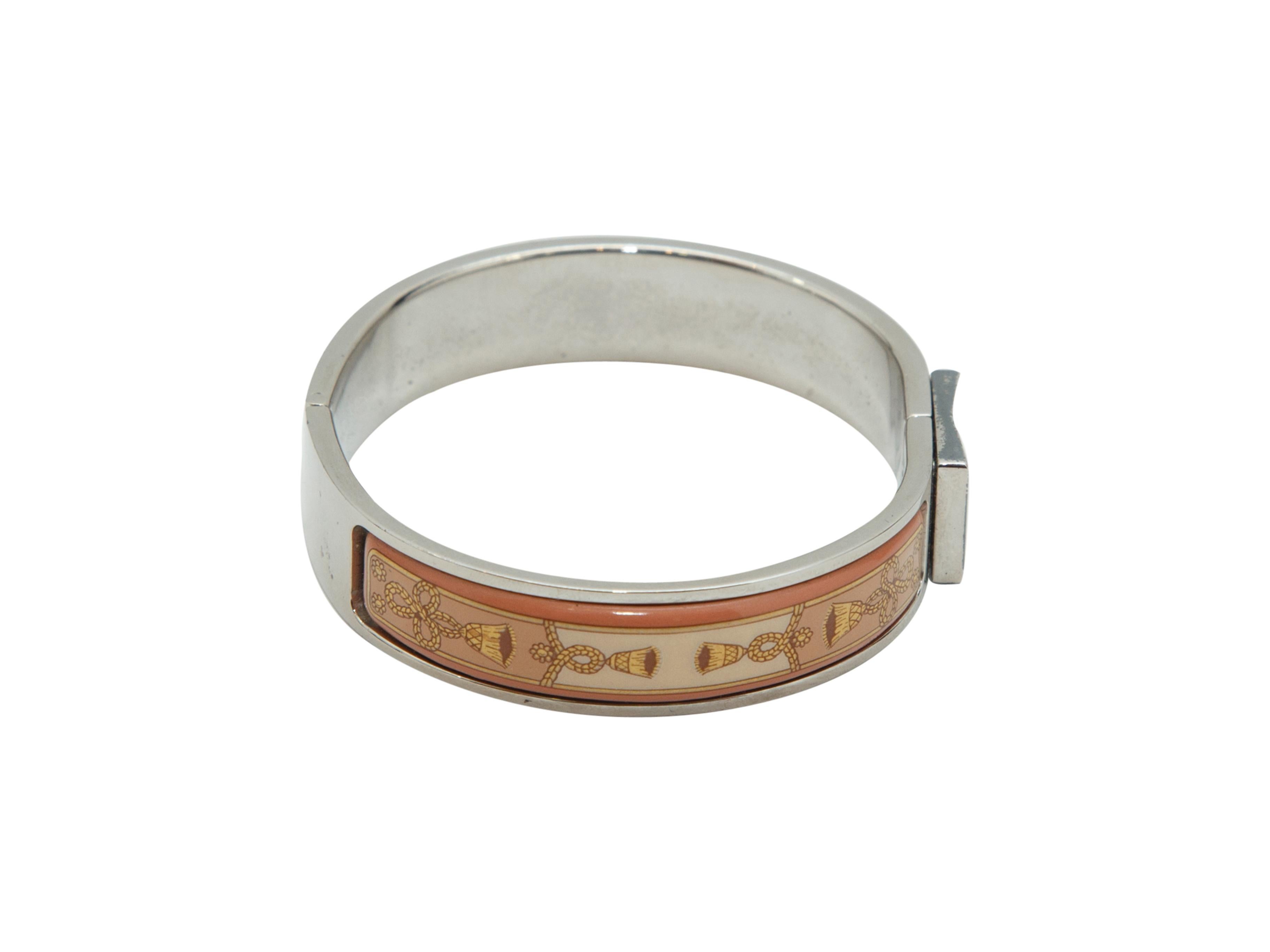 Product details: Tan, pink and silver vintage Clic Clac enamel bracelet by Hermes. Snap closure at top. 6