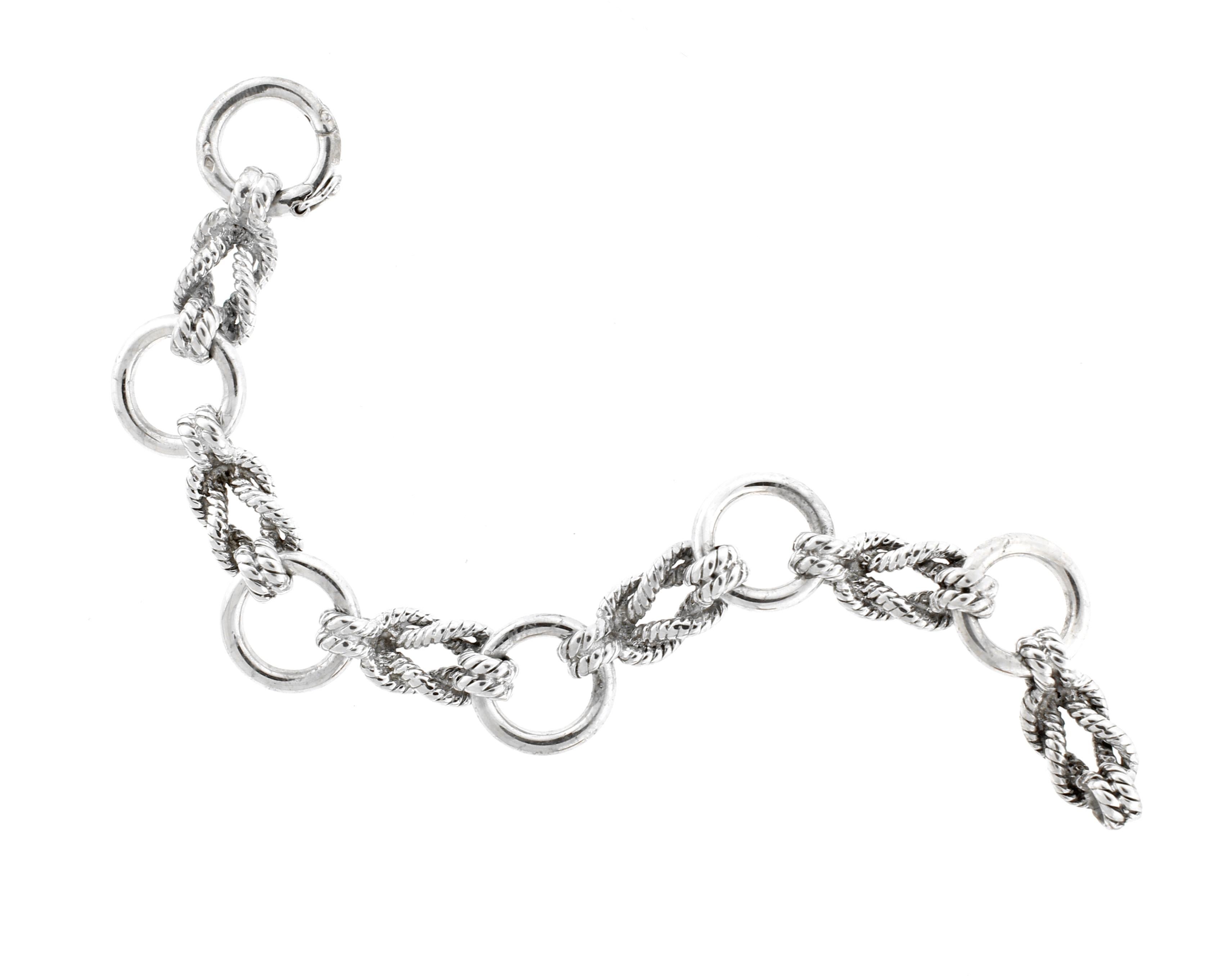 Silver Bracelet in the sailor's knot design by Hermes. The silver rope links are spaced with silver rings and shaped so that it fits the wrist. 7½ inches