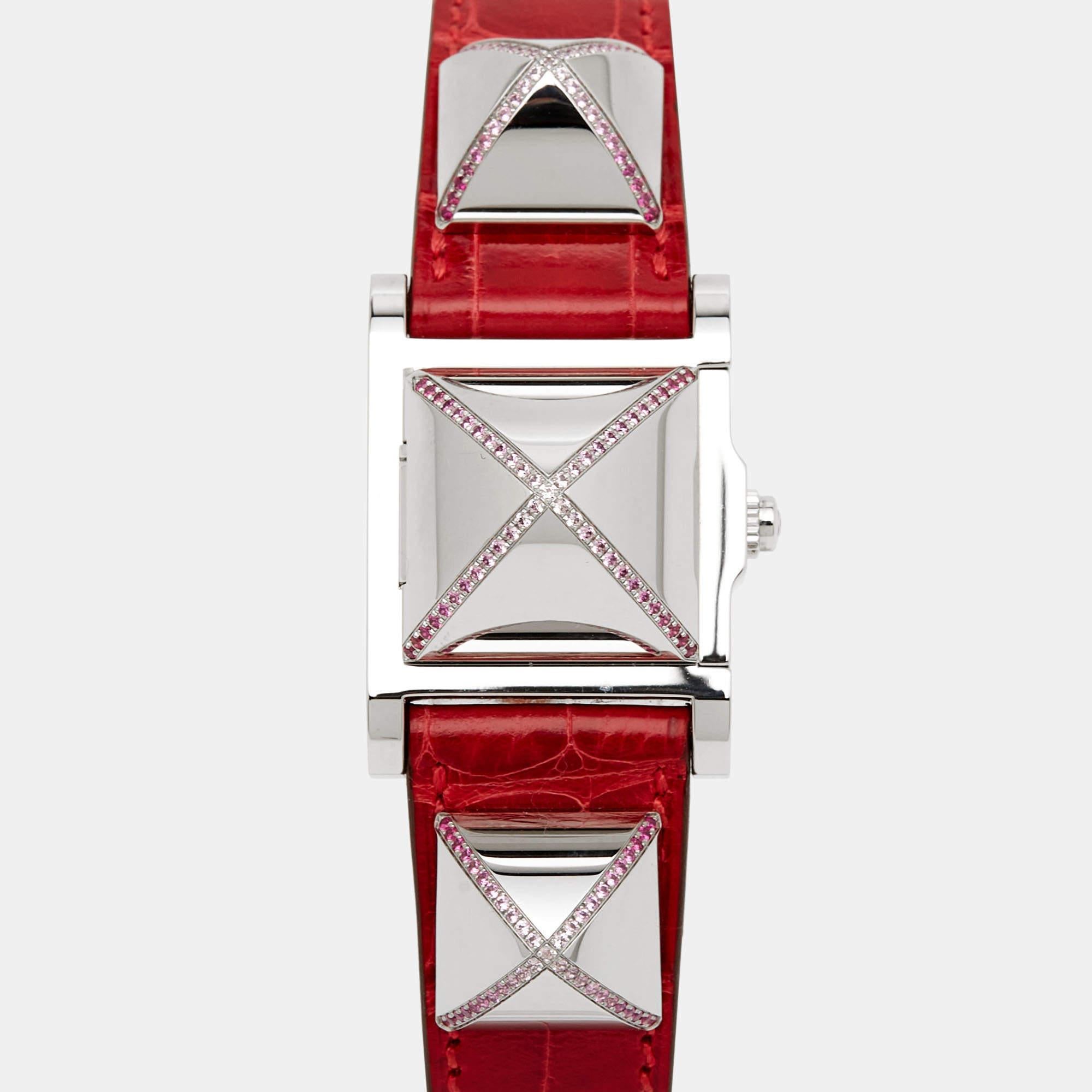At first glance, one would think this piece is a bracelet, but it is a wristwatch. It is such a versatile creation. It has pyramid studs, and the largest one in the middle is the case of the watch. The stud must be lifted to reveal the dial housing
