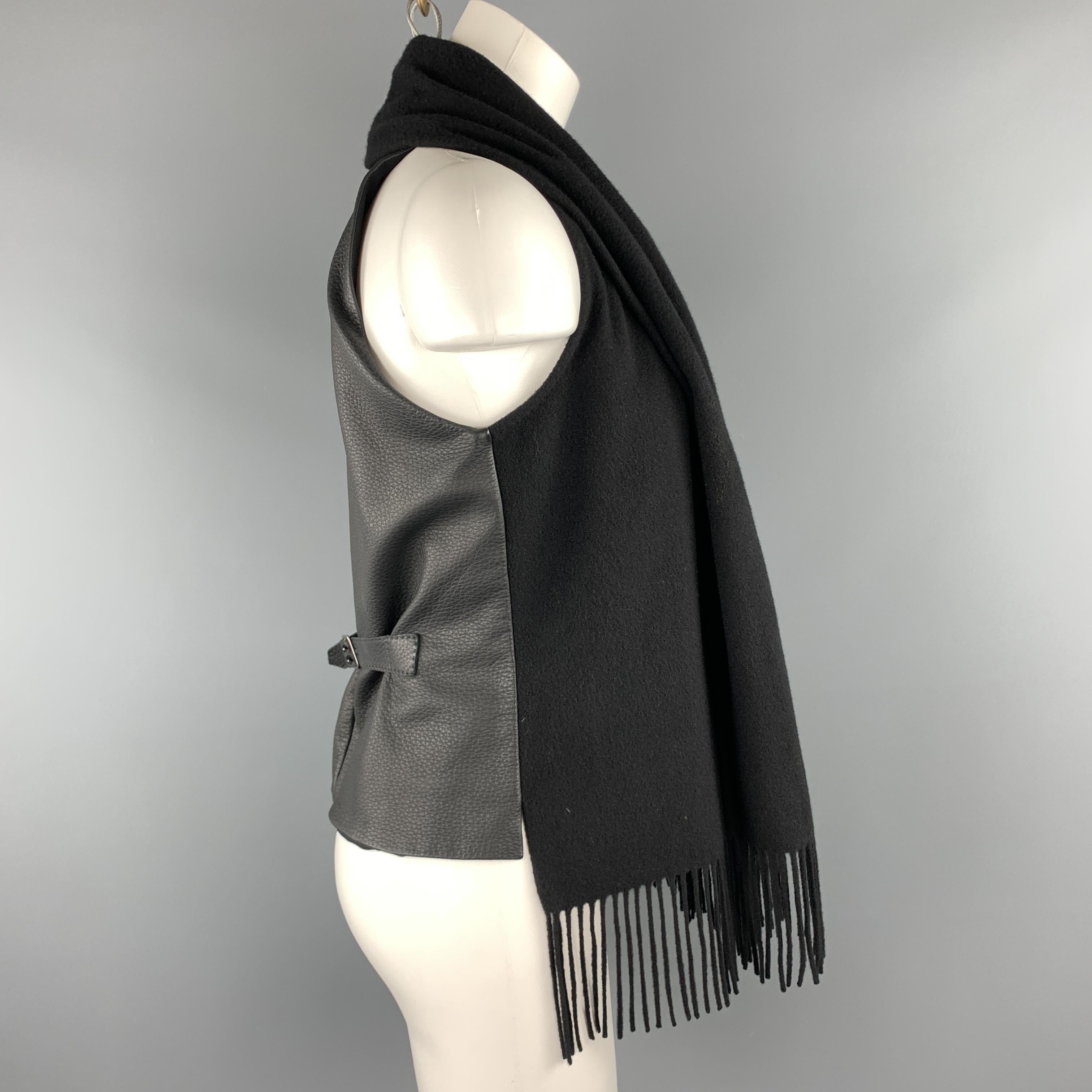 HERMES vest features a cashmere frontal panel with a fringe trimmed scarf lapel collar, textured leather back with belt, and silk liner. Made in France.

Excellent Pre-Owned Condition.
Marked: FR 40

Measurements:

Shoulder: 9 in.
Bust: 38