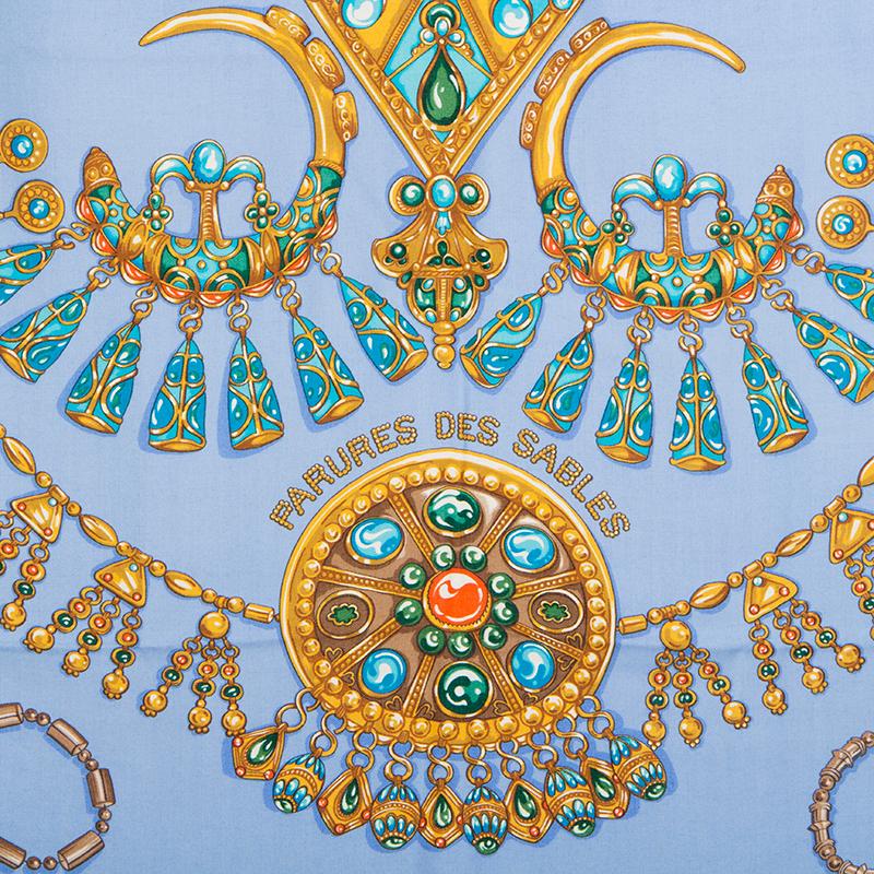 Hermes 'Parures de Sable 140' shawl by Laurence Bourthoumieux in sky blue cashmere (70%) and silk (30%) with dark blue border and contrast medium blue hem. Details in antique gold, turquoise, coral and dark green. Brand New.

Width 140cm