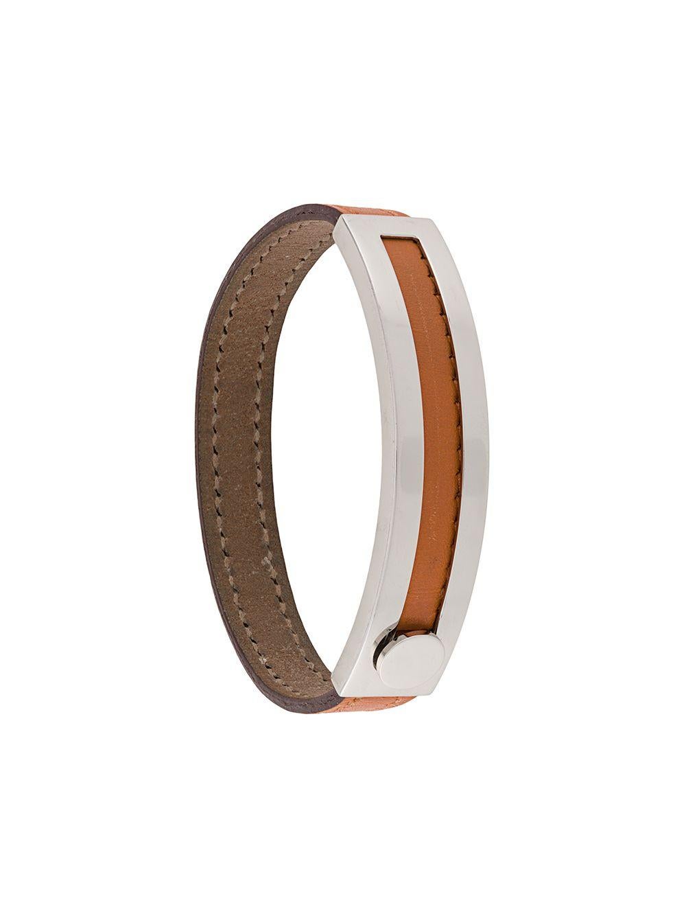 Crafted in France from a combination of beautiful orange leather and silver-tone metal hardware, this luxurious yet simple bangle bracelet from Hermès boasts a slim, two-tone design, a sliding clasp fastening and engraved metal detailing.

This bag