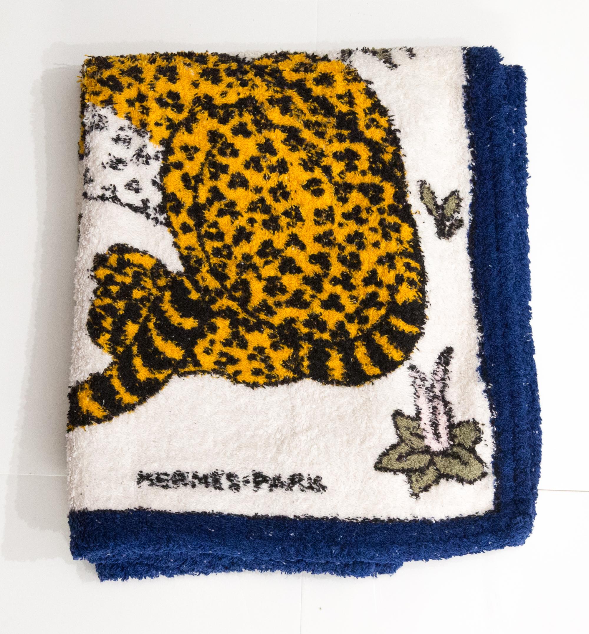 Hermes Small Size blue terry cotton Beach towel ”Léopards” by Christiane Vauzelles featuring a blue border and a top logo signature.
Circa 2000s 
In good vintage condition  Made in France.
23.6in. (60cm) X 37.4 in. (95cm)
We guarantee you will