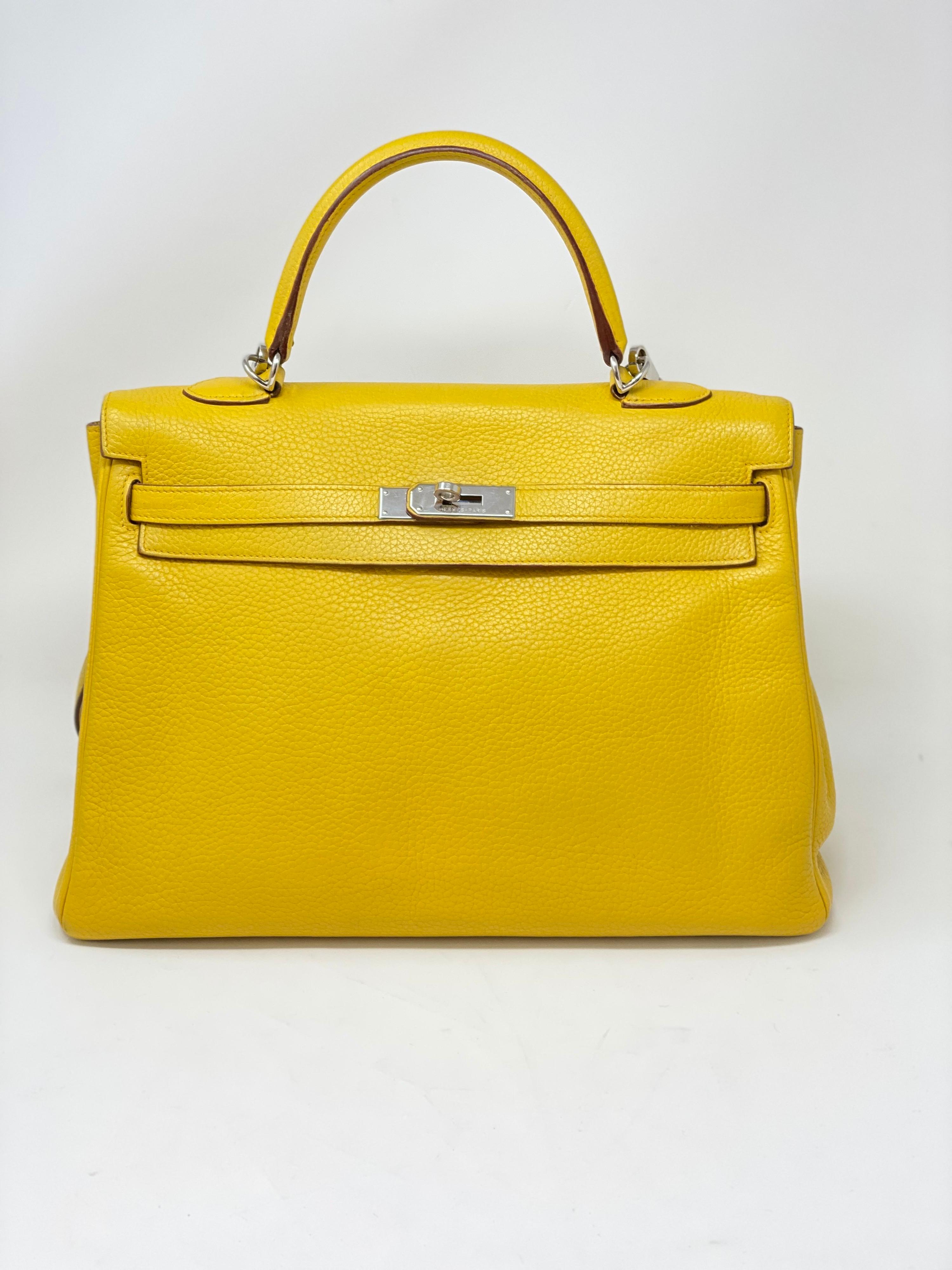 Hermes Soleil Yellow Kelly Bag. Beautiful bright yellow color. Clemence leather. Good condition. Palladium hardware.  Includes dust cover, clochette, lock, and keys. Guaranteed authentic. 