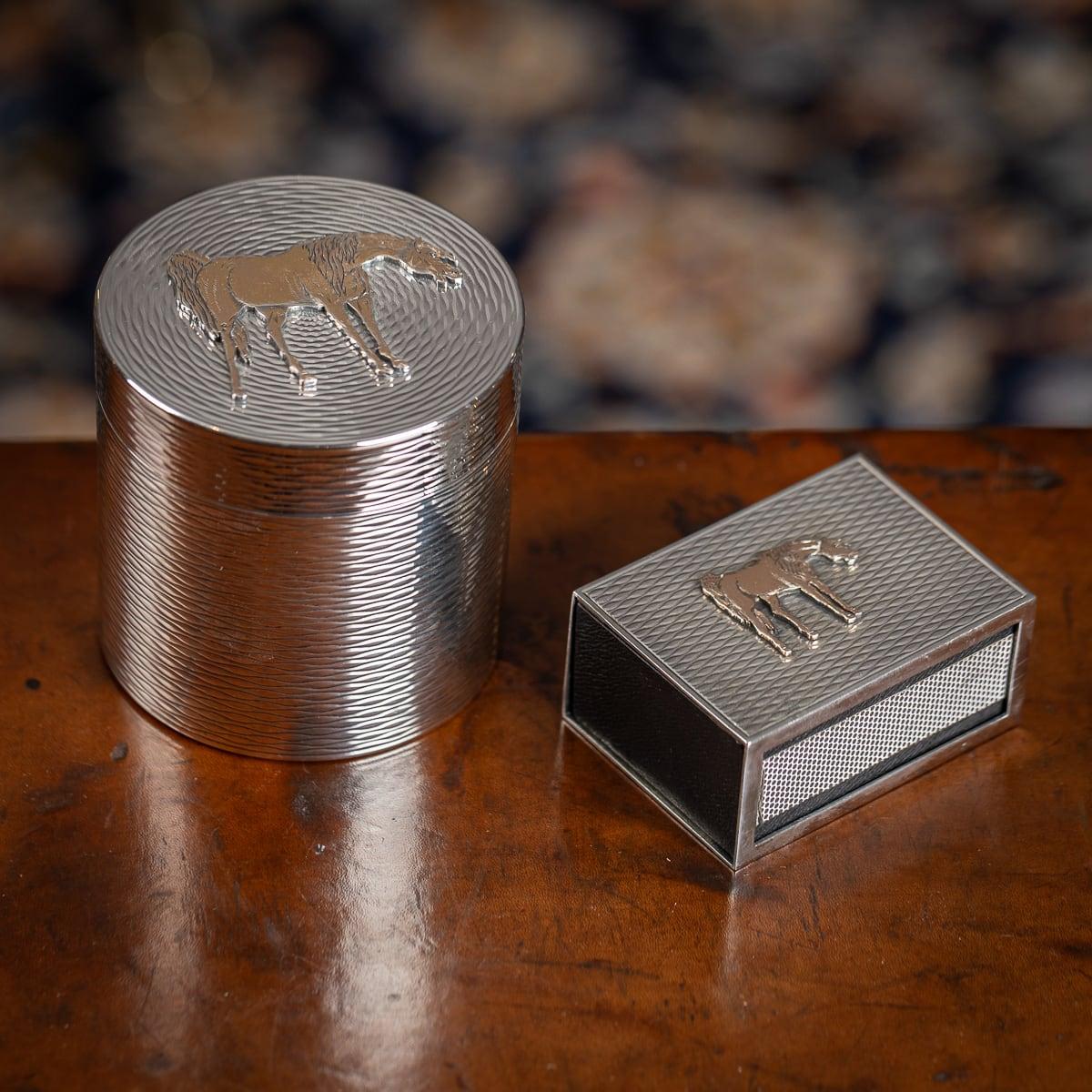 A Vintage mid-20th Century Hermes cigarette box and matchbox holder crafted from solid silver, adorned with exquisite gold horse detailing. This exceptional set, dating back to 1960, epitomises luxury in smoking accessories. Consisting of a circular