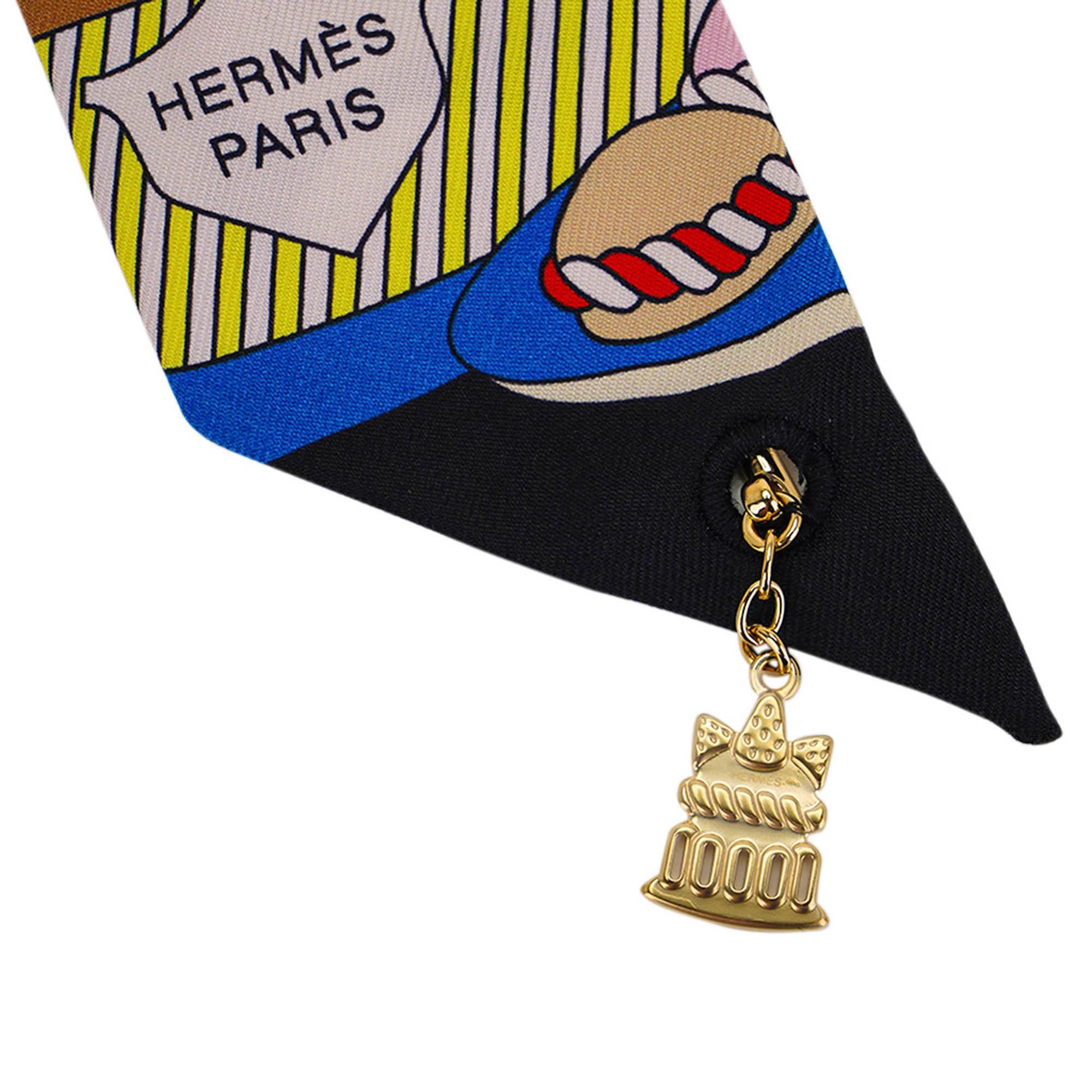 Mightychic offers an Hermes silk scarf Special Edition Charm La Patisserie Francaise Charm Twilly set of 2.
Featured in Noir, Blanc and Bleu colorway.
Designed by Pierre Marie.
Pays tribute to the 20th anniversary of the Twilly scarf.
A small charm