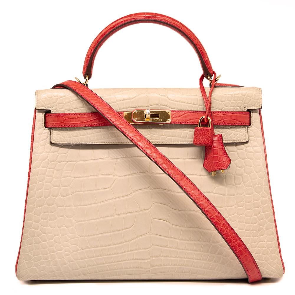 This Special Order 32cm Bi-colour Kelly bag from Hermès is a true testament to the quality of the house's craftsmanship, exuding timeless style and elegance, perfect for any occasion with a striking combination of Beton and Geranium Alligator