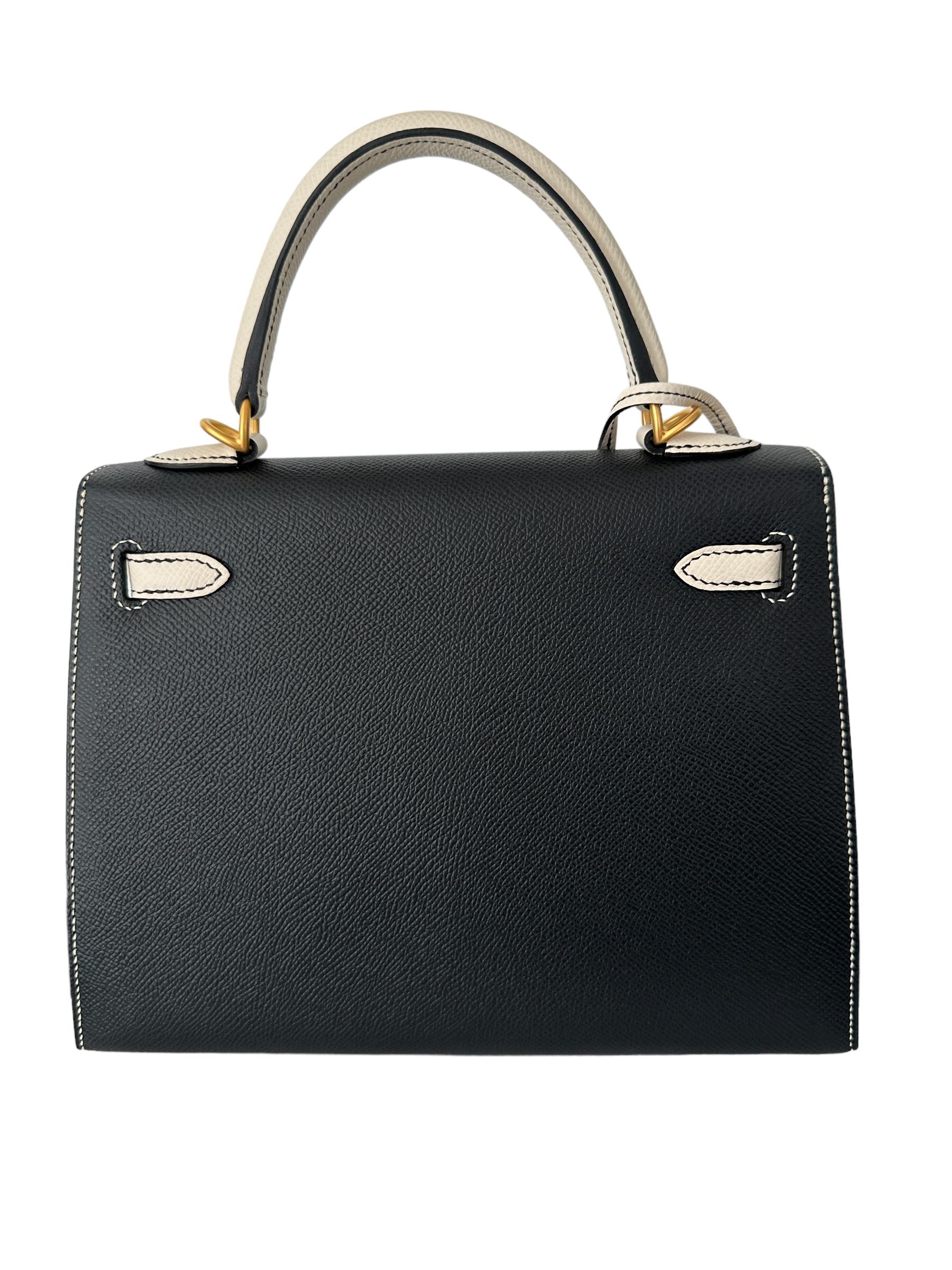 This Special Order Kelly, in the Sellier style, is in Black and Craie epsom leather with brushed gold hardware 
Contrast Stitching, so chic!
Removable shoulder strap
Original plastic on all the hardware including shoulder strap


The Hermes Special