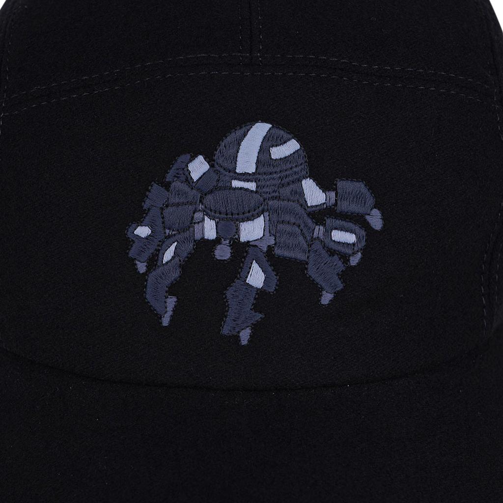 Mightychic offers a limited edition Hermes Black cashmere Spider Robot cap.  
The cap shows a blue and gray embroidered robotic spider across the front center.
2 Hermes Paris Clou de Selle snaps at rear. 
Identical cap under separate listing in navy