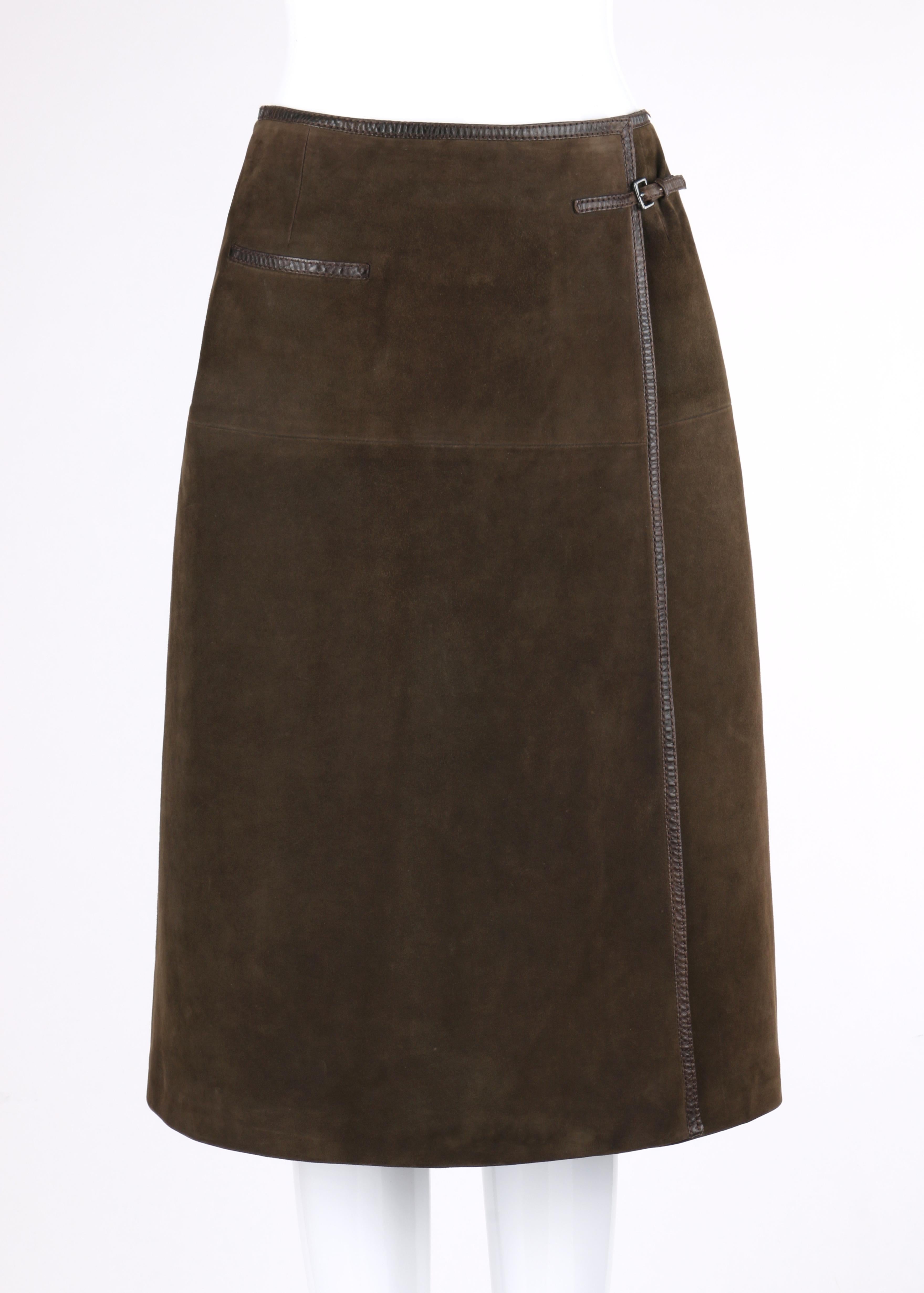 HERMES Sport c.1970's Brown Suede Classic Leather Wrap Skirt

Circa: 1970's
Style: Wrap skirt
Colors: Shades of brown (exterior, interior, detail); shades of nickel and gold (hardware)
Lined: Yes
Unmarked Fabric Content: Leather (exterior); acetate