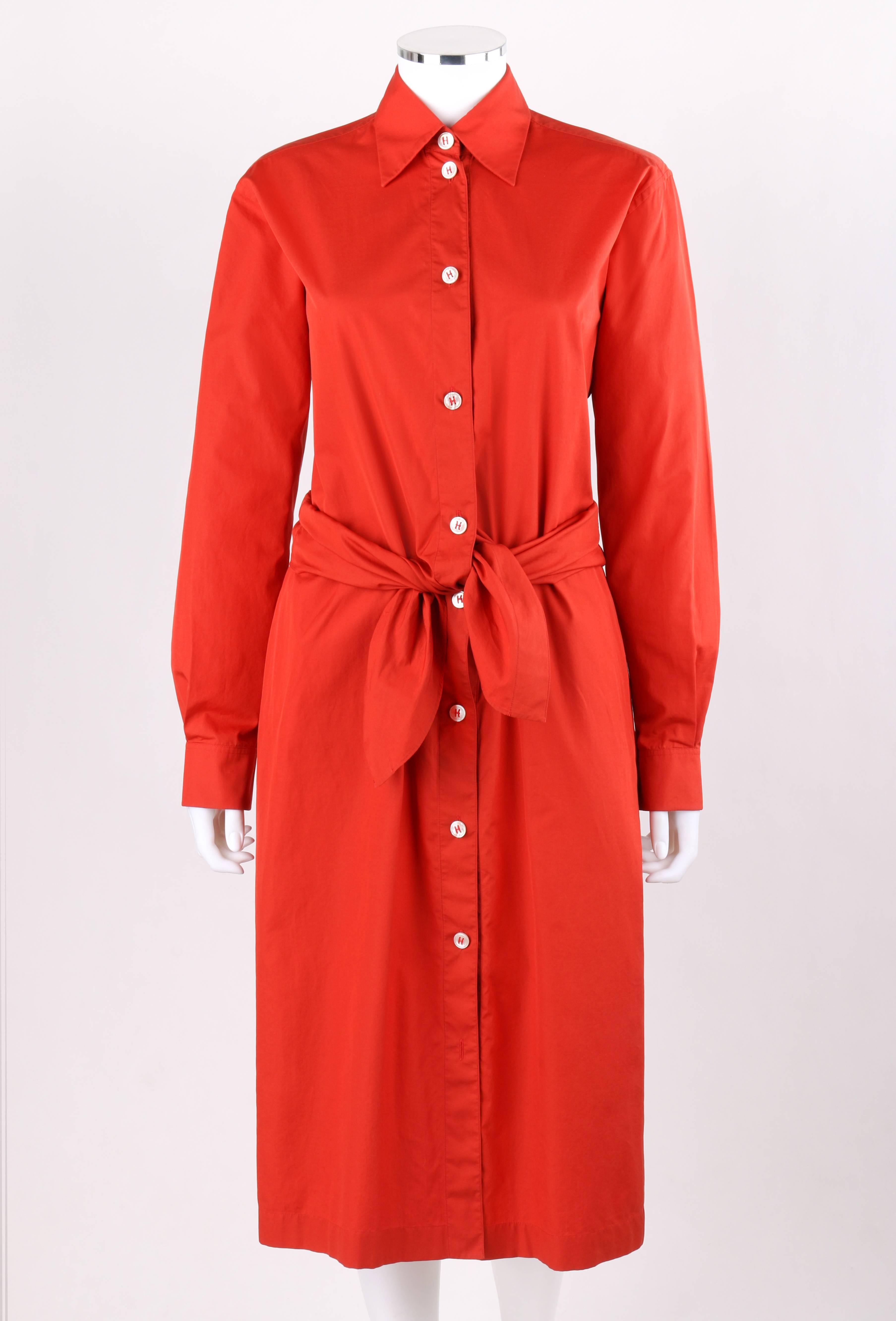 Hermes Spring / Summer 2004 coquelicot cotton long sleeve tie front cotton shirt waist dress. Designed by Martin Margiela. Shirt collar. Long sleeves with two knife pleats at cuff. Single button closure at sleeve cuff and placket. Nine center front