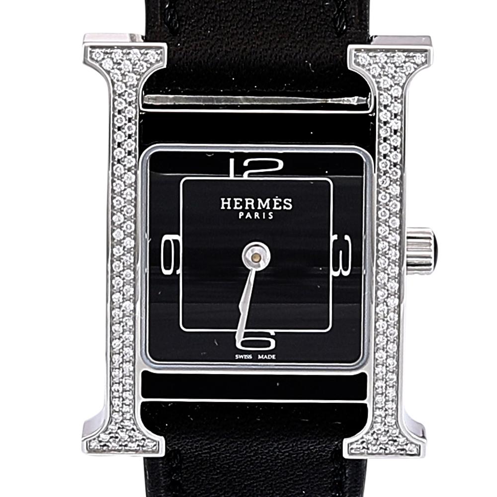 This Heure H watch from Hermes stands for quality and sophistication. The watch features a signature 'H' case in stainless steel and is held by leather straps with buckle fastenings. Powered by quartz movement, this elegant timepiece has a