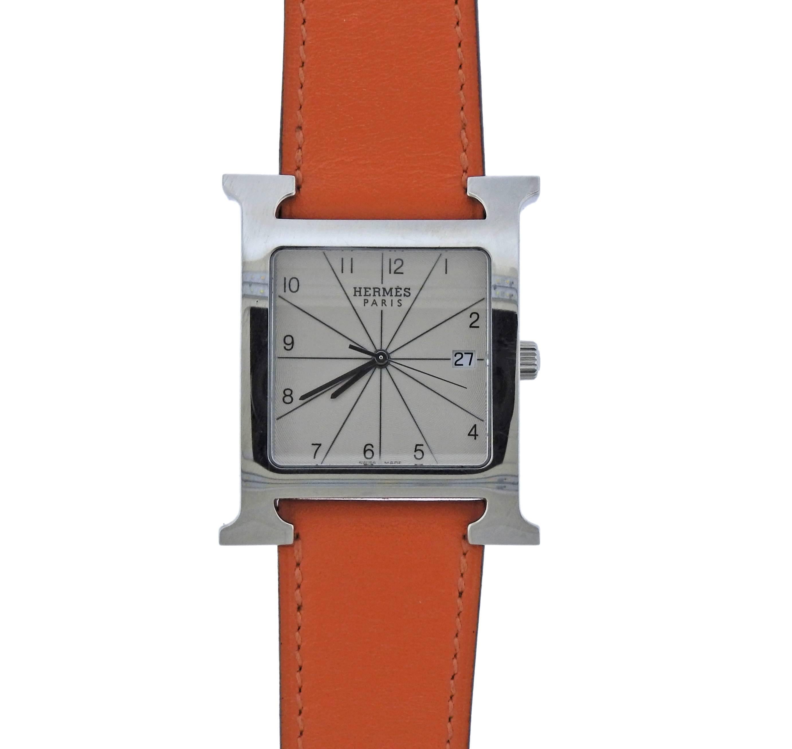 Stainless Steel large model of H hour quartz watch, crafted by Hermes, featuring signature orange color leather band. Bracelet is 8