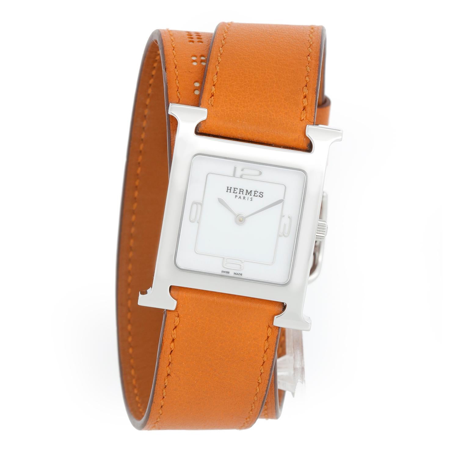 Hermes Stainless Steel Heure H Ladies Watch HH1.510 - Quartz. Stainless Steel H case ( 25 x 35  mm ) . White dial with Arabic numerals . Hermes leather wrap around strap with Hermes buckle. Pre-owned with Hermes box
