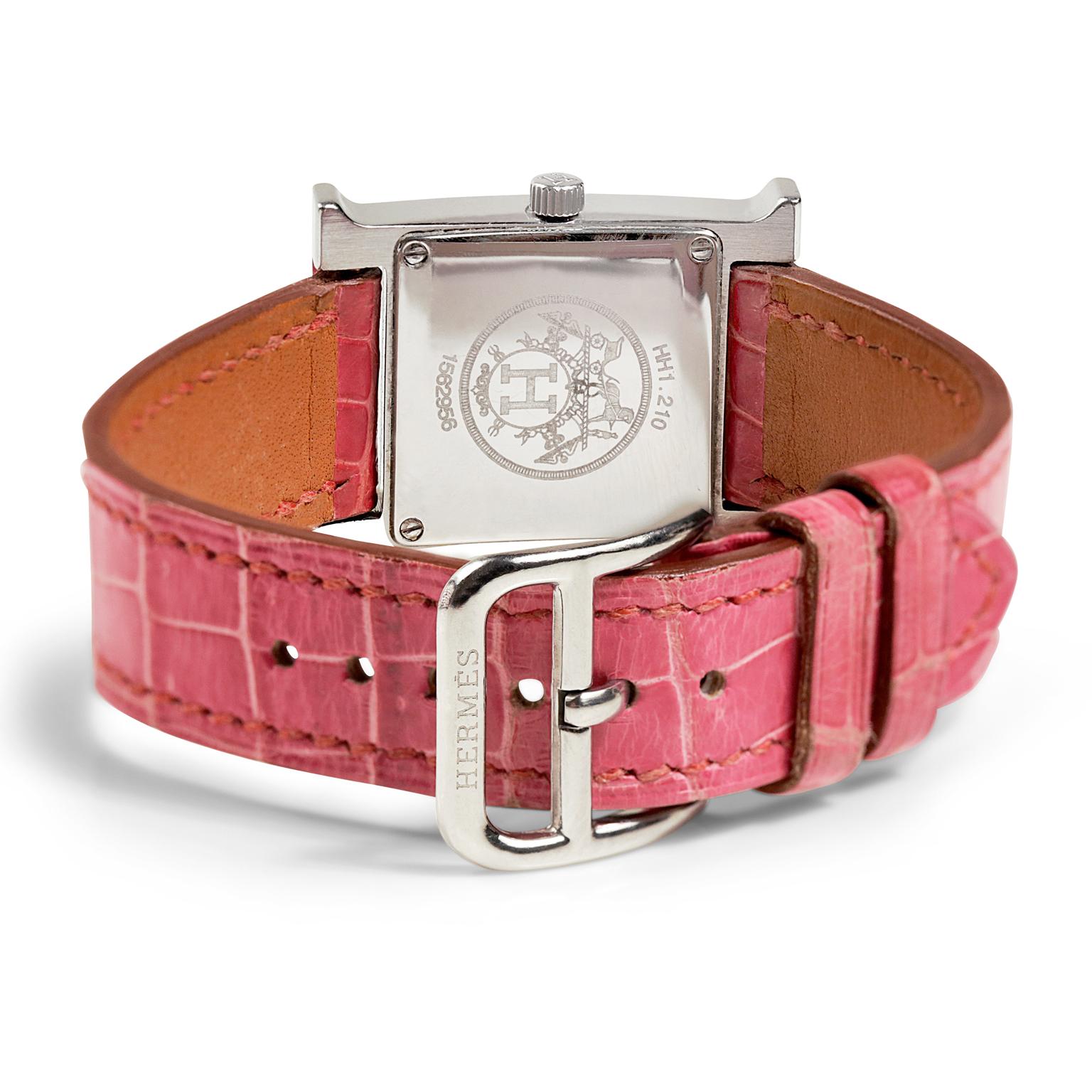 This authentic Hermès Stainless Steel Heure H Watch is in very good overall condition.  Stainless steel casing, pink porosus crocodile band.  
 
