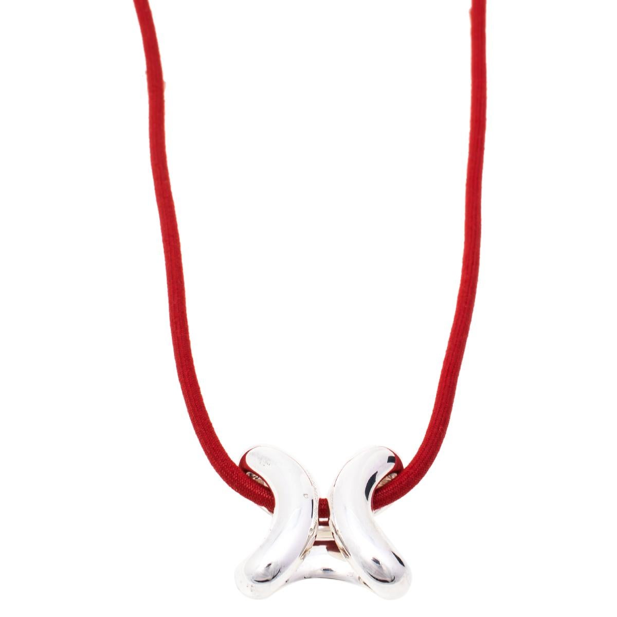 This necklace from Hermes exemplifies minimal style with a stunning carved pendant. The pendant is crafted from silver to a smooth finish and held by a red cord. We're sure this creation will elevate the way you accessorise.

Includes: Original Box,