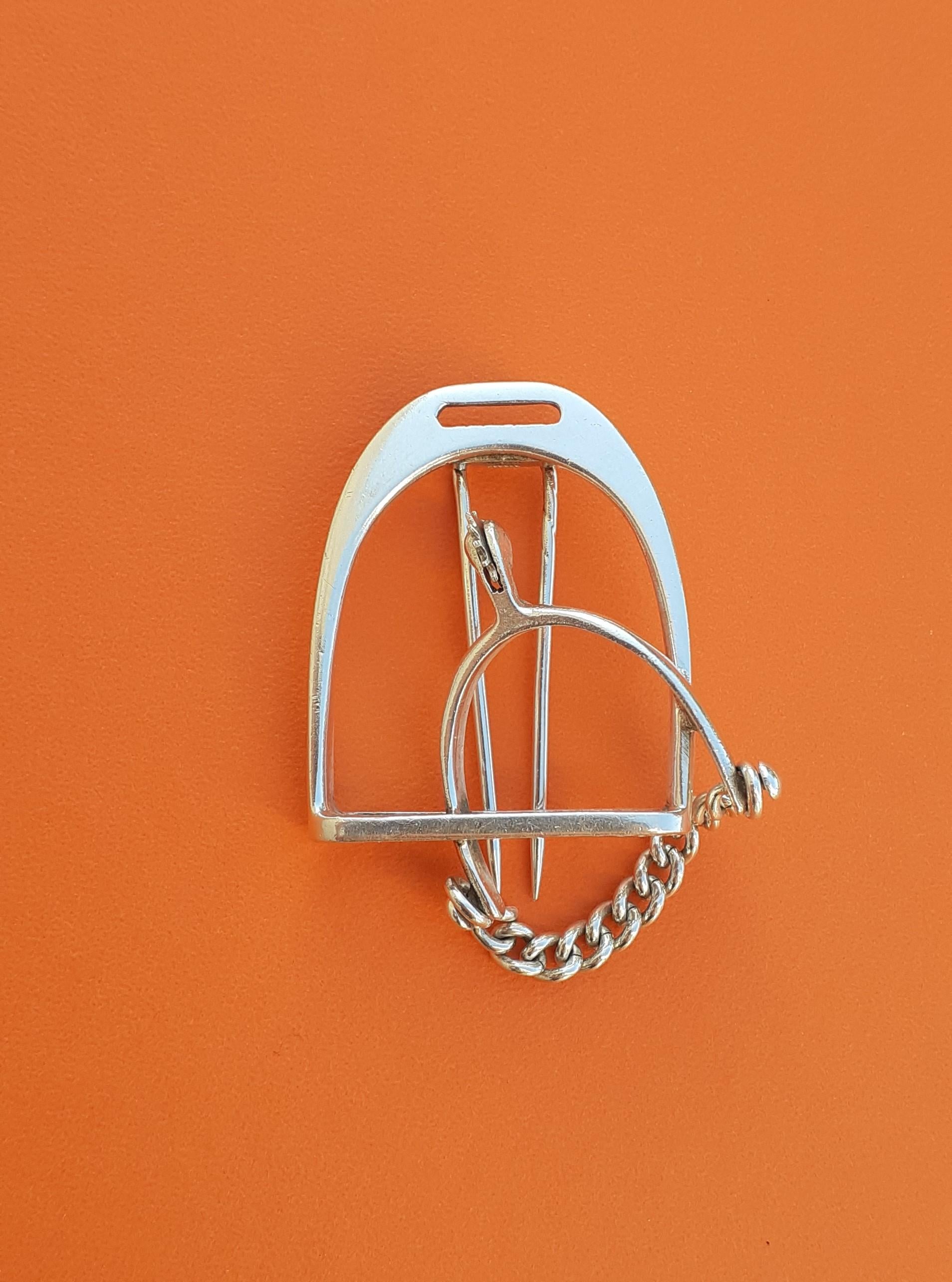 Lovely and Rare Authentic Hermès Brooch

In shape of a stirrup, adorned with a cute small spur

Like the big ones, the spur even has its own little rowel that turns and its chain

Made of silver (crab hallmarks)

Vintage Item

