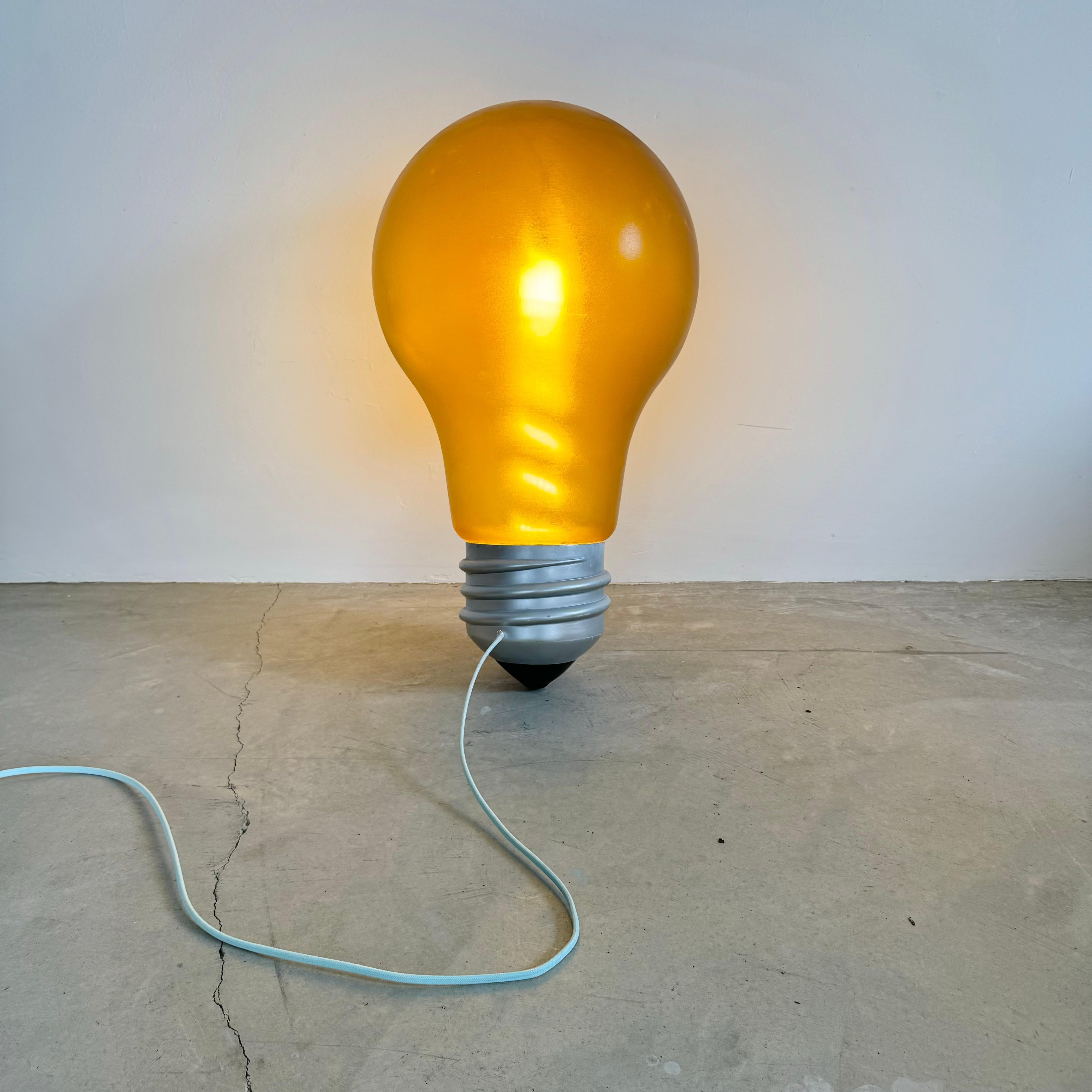 Magnificent and massive lightbulb lamp. Emits a beautifully tinted light that fills the room with a golden glow. 

Made for the Hermes store window display.

This functional piece of art would look great hanging from the ceiling, off the wall,