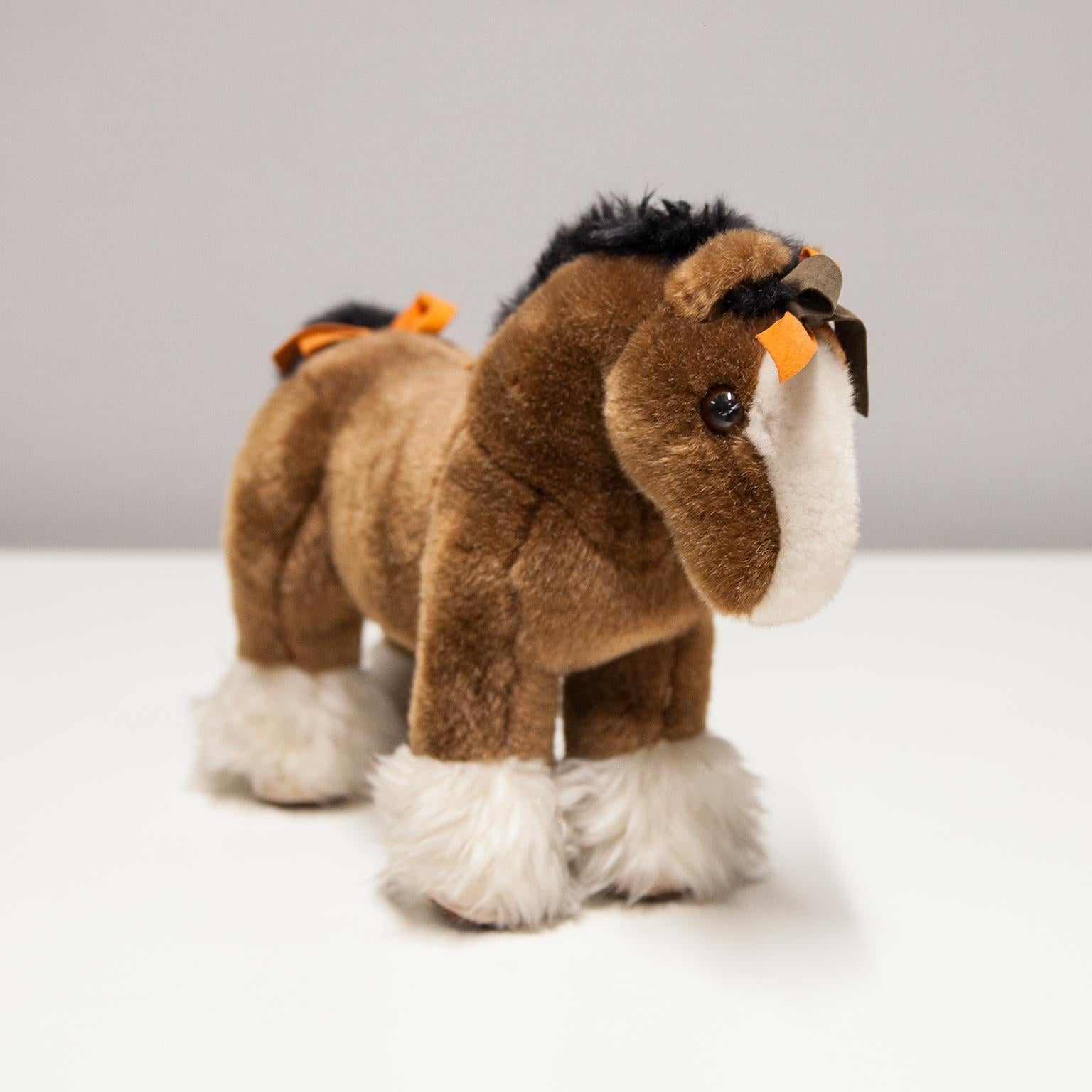 Hermes Hermy The Horse small plush toy 100% authentic. The outside is 100% acrylic, while the inside is 100% polyester, as shown on the label. The horse’s hair, in brown color, is very soft and in very good vintage condition.