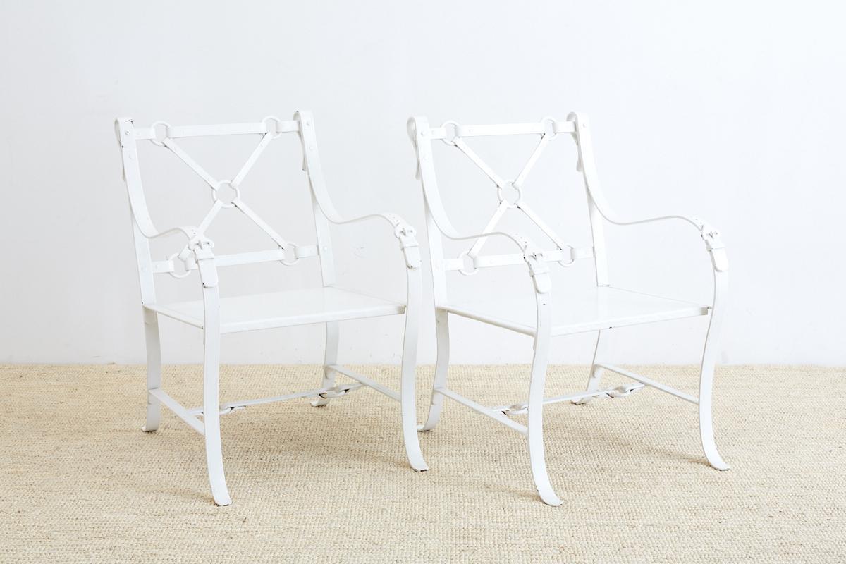 Elegant faux leather iron belt strap chairs made to look like equestrian leather straps in the manner and style of Hermes and Jacques Adnet. Beautifully detailed and lacquered in a white finish. These garden chairs are very heavy, solid construction