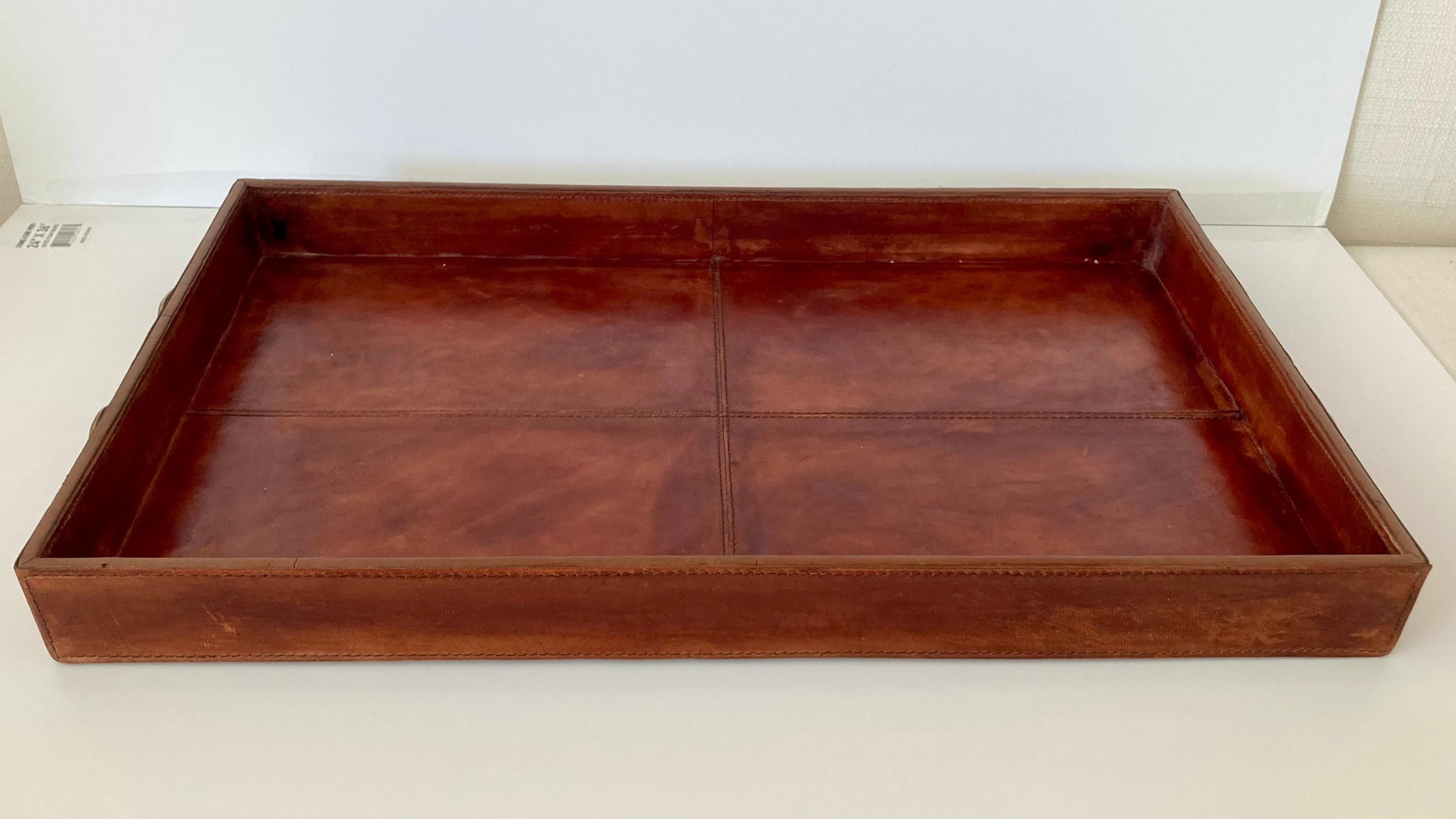 Beautiful vintage Hermes style leather serving tray from the 1970s. Gorgeous leather and hardware on the handles. Use as a tray, or as a beautiful centerpiece on your coffee table.