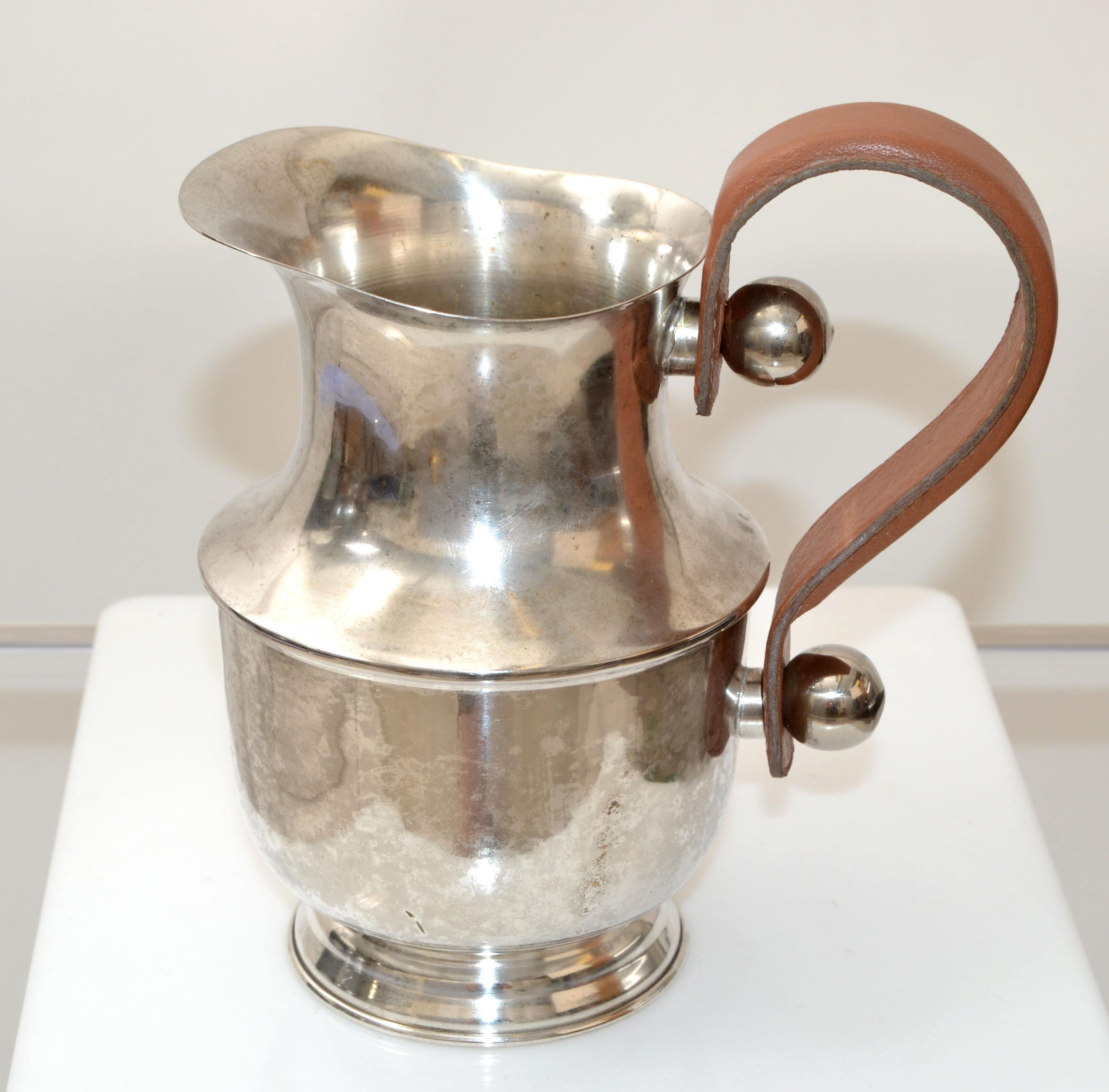 Mid-Century Modern handcrafted silver plate over nickel decanter, vessel, carafe and leather handle.
All original condition with age related patina.

 
