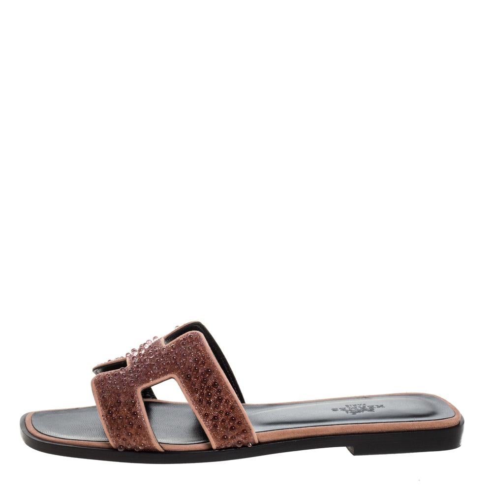 Put your best foot forward this season in these pretty Hermes sandals. These beige Oran sandals have been crafted from suede and leather in Italy and they feature pearl embellishments on the iconic H-shaped vamps. These sandals, complete with