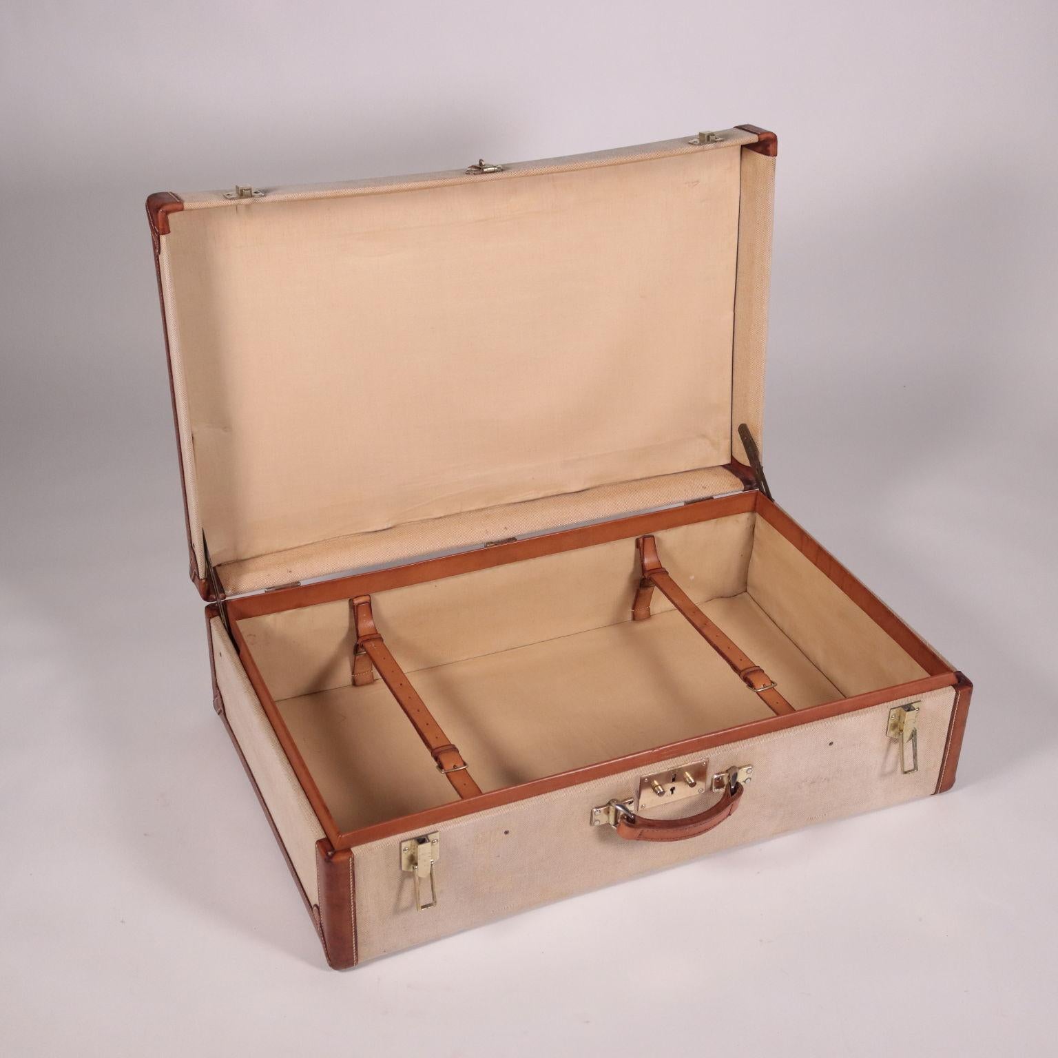 1940s-1950s Hèrmes fabric suitcase. Measure: 74cm
Squared shape with leather edgind and handle (not original handle); the closures are engraved and the interior is lined and has straps.