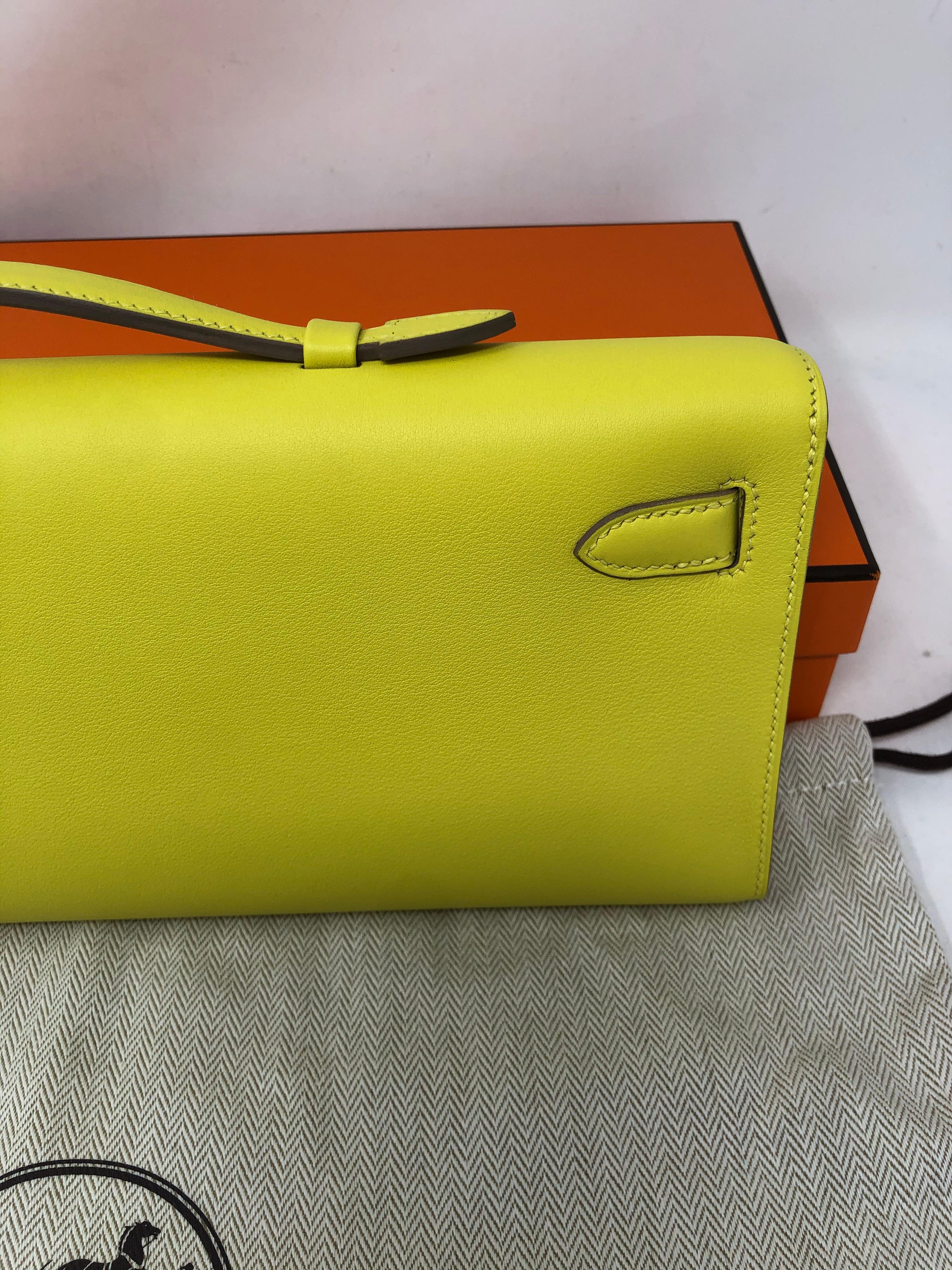 Hermes Swift Leather Kelly Cut Clutch in Yellow. Brand new Kelly Clutch with gold hardware. From 2019. Bright canary yellow in swift leather. Hard to get and rare. Never used. Plastic still on hardware. Don't miss out on this one. Includes original