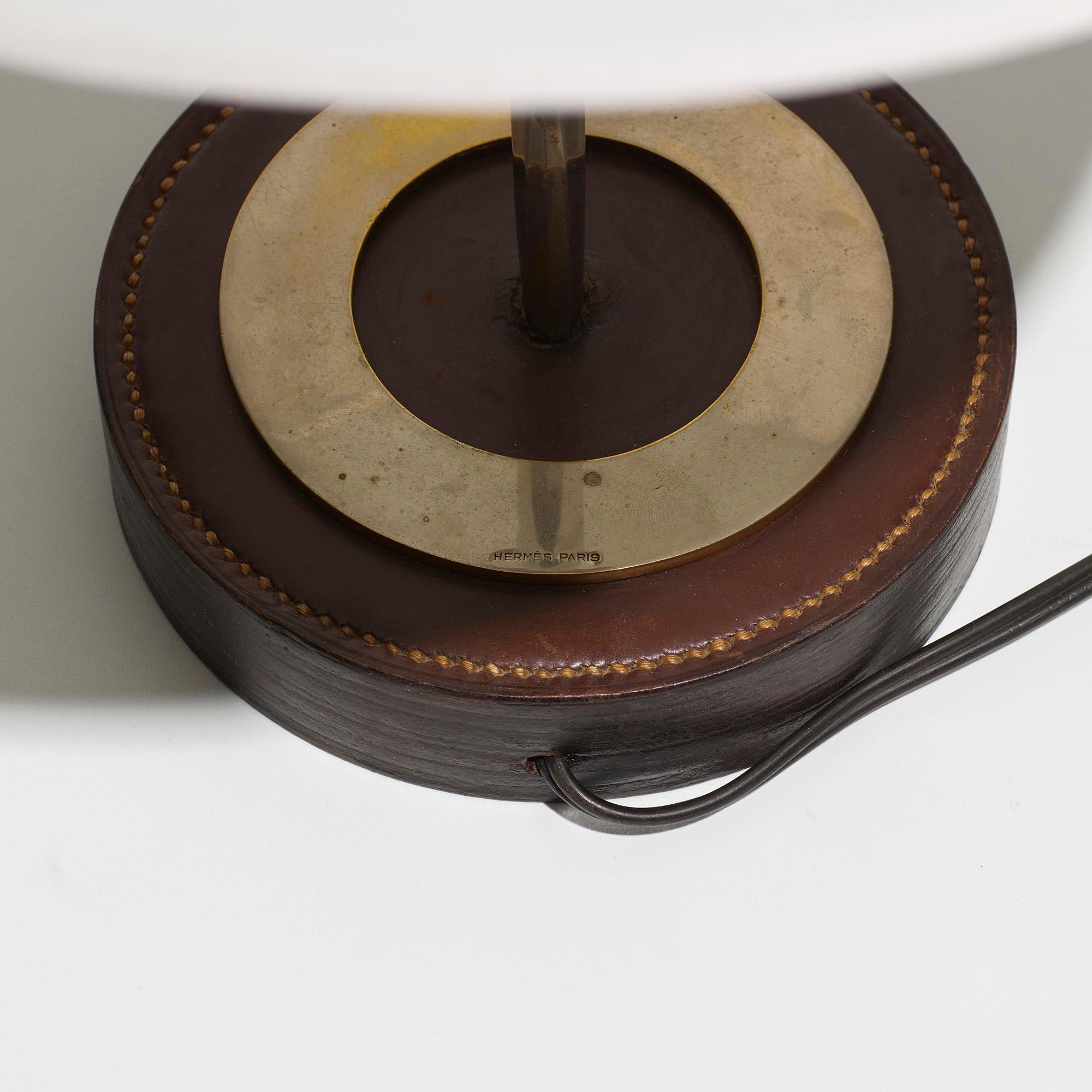 Made in: France, c. 1950

Material: stacked box leather, nickel-plated brass, brass, paper

Size: 12 diameter × 16.5 height in

Description: Signed to base ‘Hermès-France 24 FG ST Honore’.