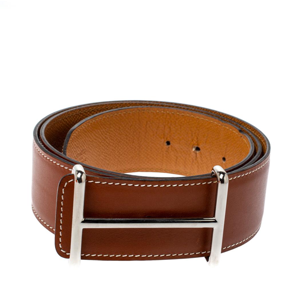 Keep yourself in style with this attractive Hermes Idem belt. The striking piece features a tan and brown reversible leather strap, Idem silver-tone buckle, and peg-in hole closure. Get an effortless fashion-forward look with this alluring